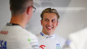 AUSTIN, TEXAS - OCTOBER 17: Liam Lawson of New Zealand and Visa Cash App RB looks on in the garage