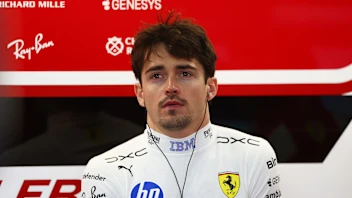 SUZUKA, JAPAN - MARCH 27: Charles Leclerc of Monaco and Scuderia Ferrari looks on in the garage