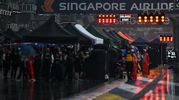 SINGAPORE, SINGAPORE - OCTOBER 10: The FIA Safety Car and drivers line up on the grid prior to the