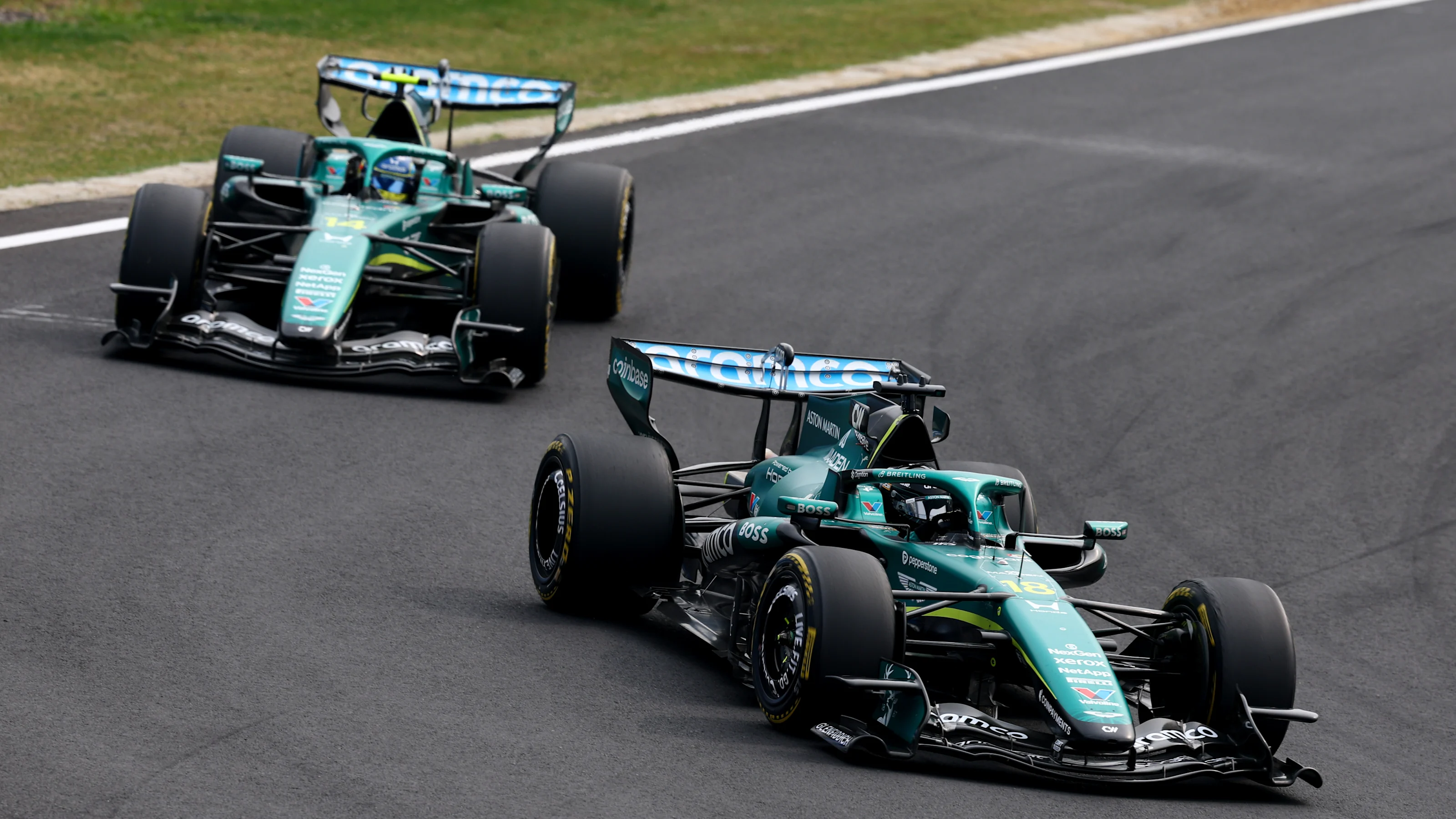 Lance Stroll leads Fernando Alonso in the two Aston Martin AMR26 cars at Suzuka Circuit