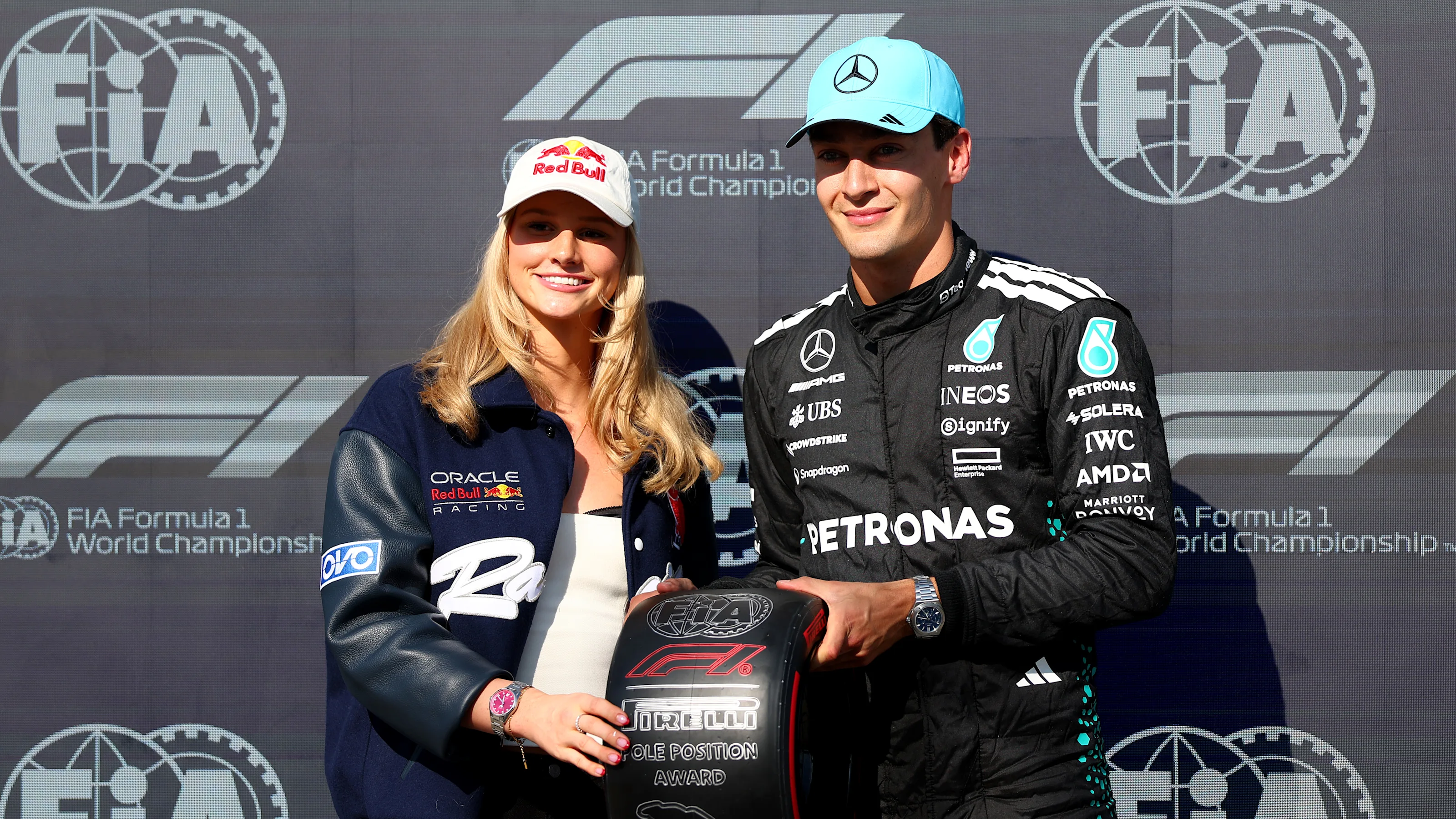 MONTREAL, QUEBEC - JUNE 14: Summer McIntosh presents Pole position qualifier George Russell of