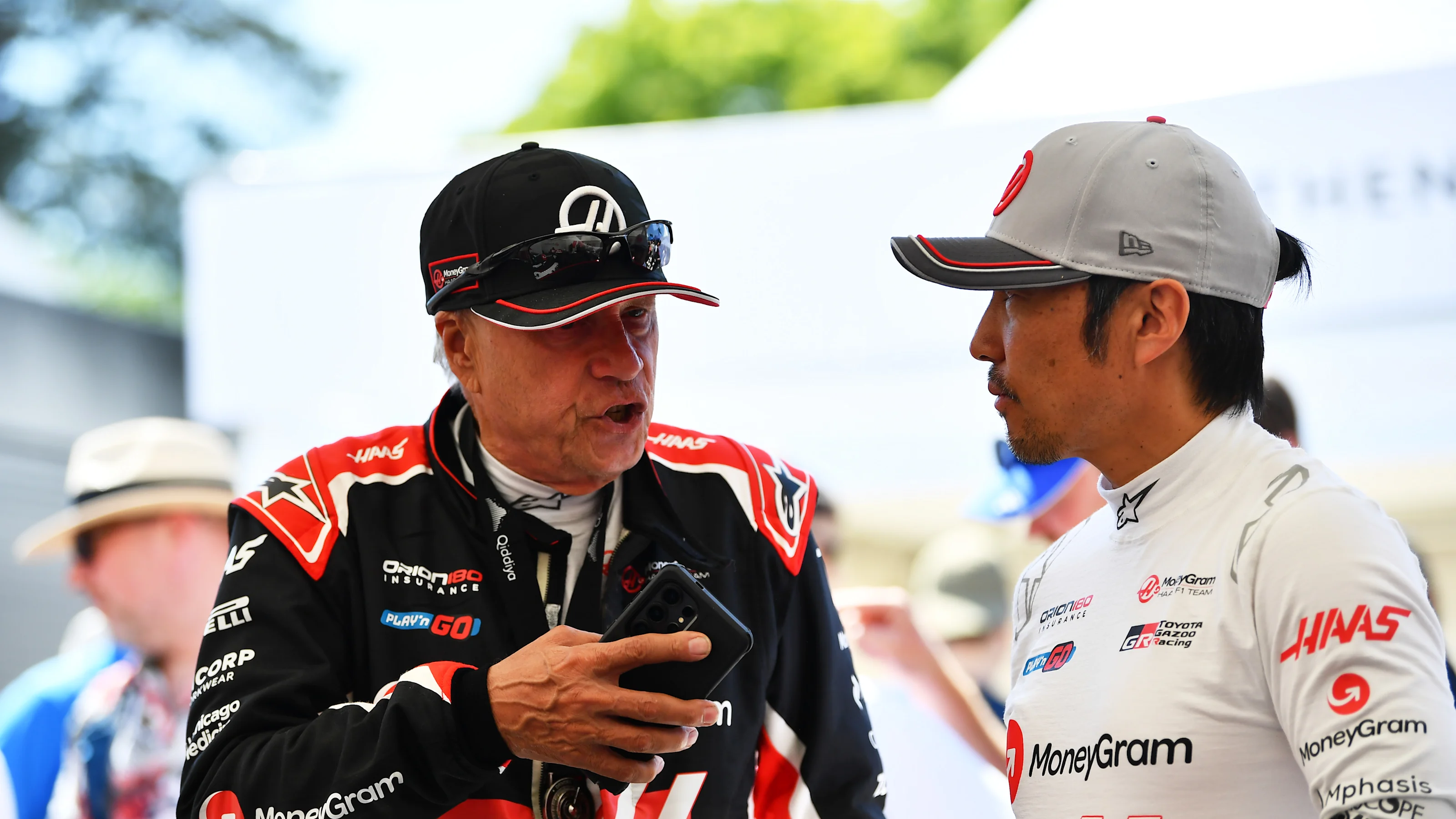 CHICHESTER, ENGLAND - JULY 11: Gene Haas, Founder and Chairman of Haas F1 talks with Ayao Komatsu,