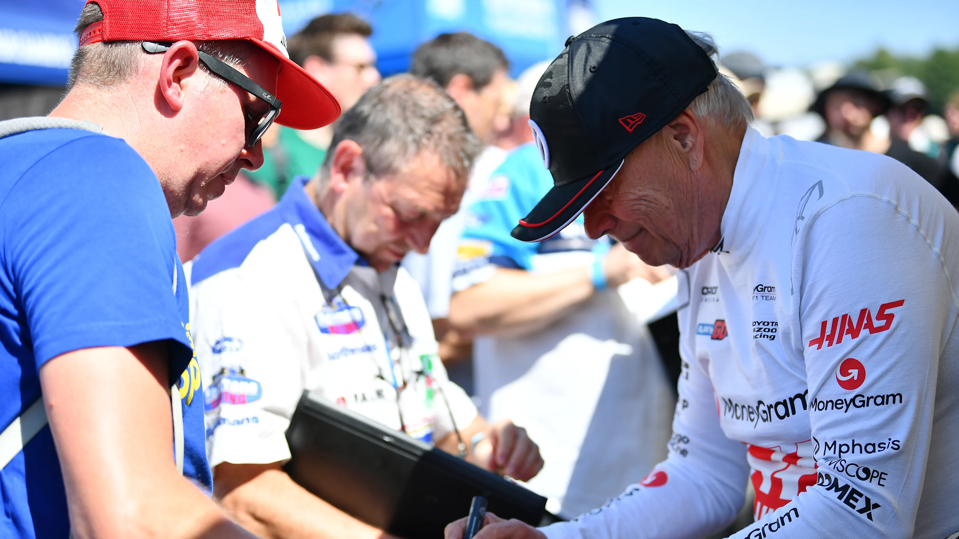 CHICHESTER, ENGLAND - JULY 11: Gene Haas, Founder and Chairman of Haas F1 signs autographs for fans