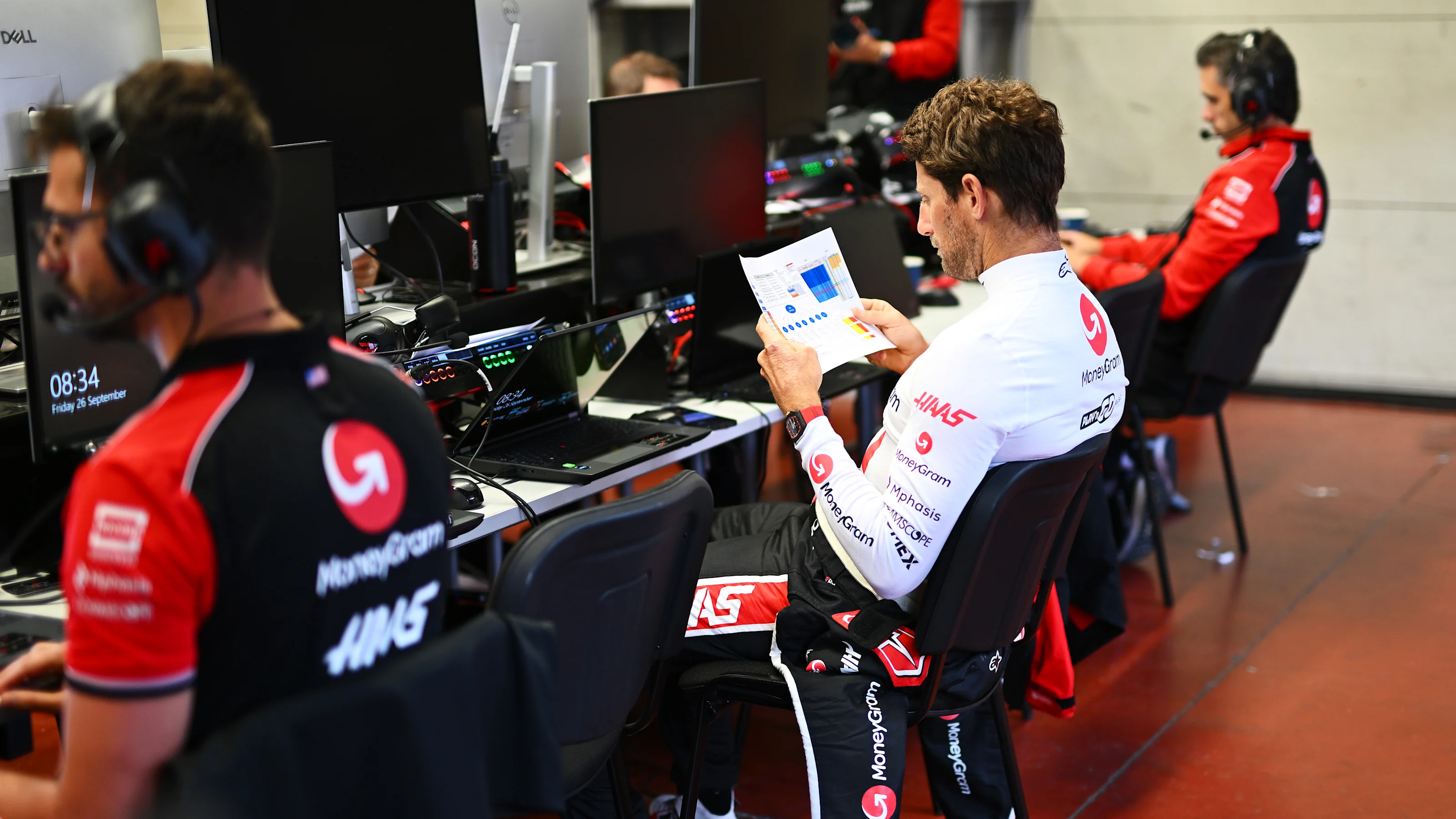 SCARPERIA, ITALY - SEPTEMBER 26: Romain Grosjean of France studies data in the garage before