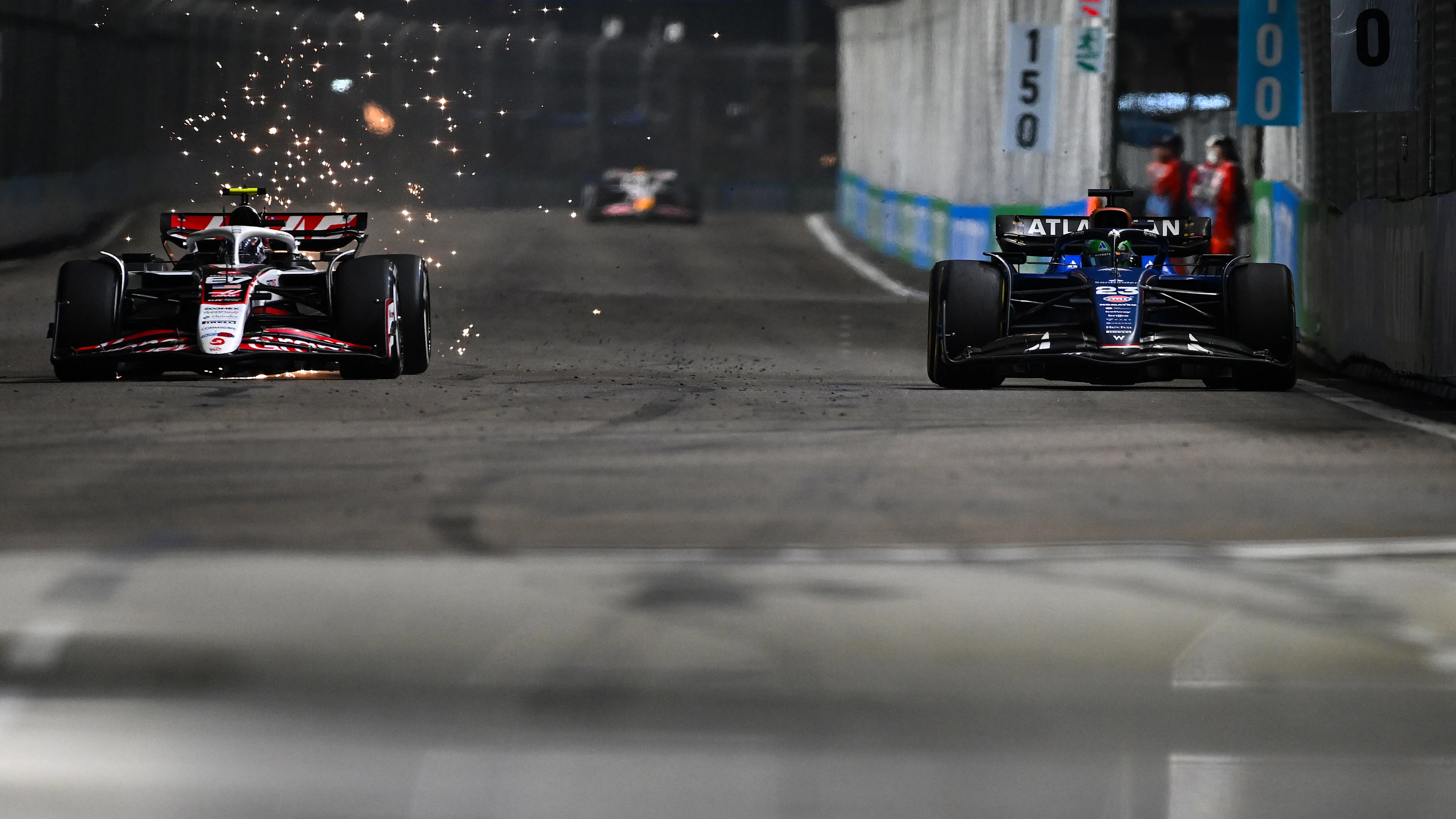 SINGAPORE, SINGAPORE - OCTOBER 05: Sparks fly behind Oliver Bearman of Great Britain driving the