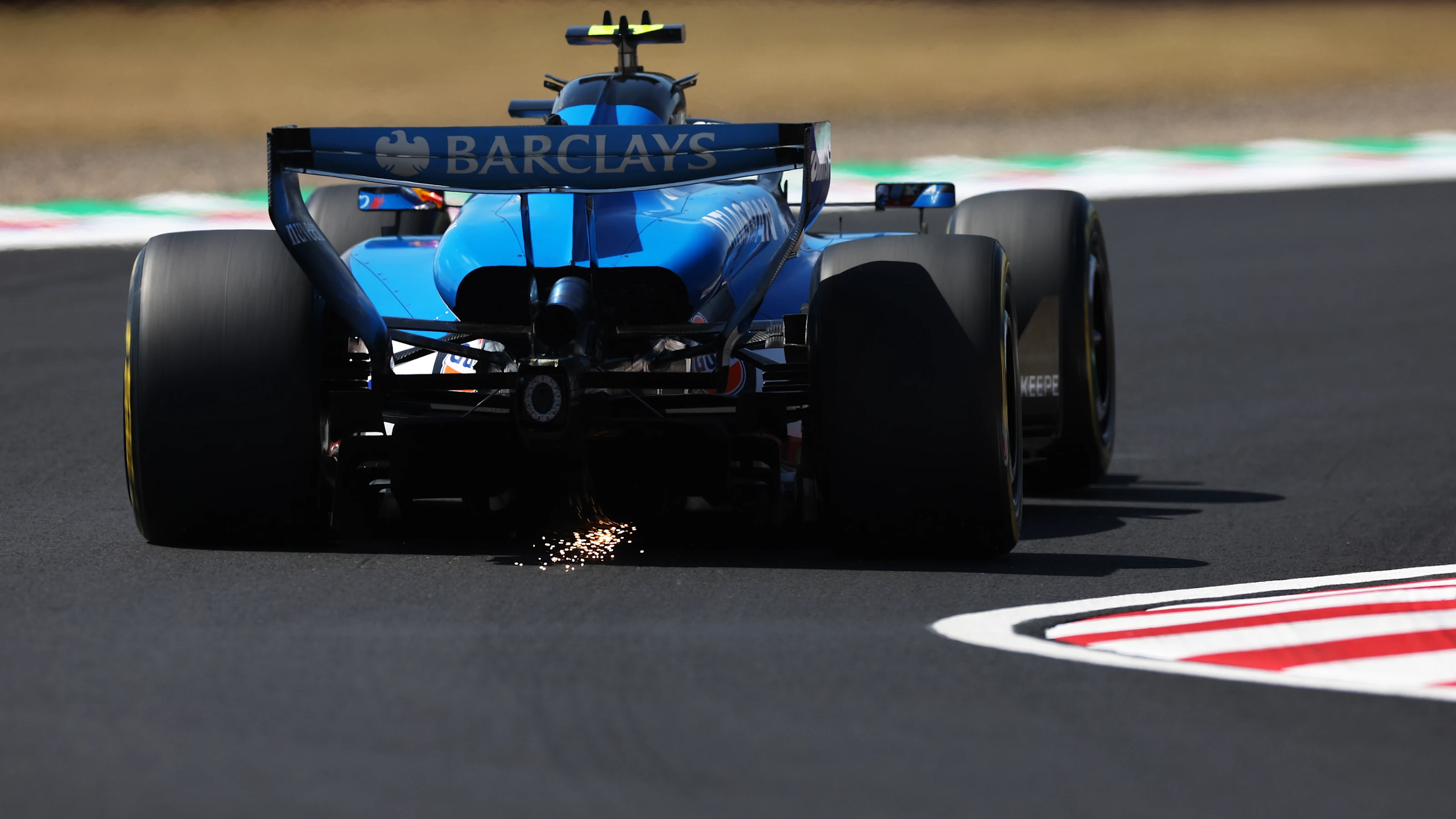 SUZUKA, JAPAN - MARCH 27: Sparks fly behind Carlos Sainz of Spain driving the (55) Williams FW48