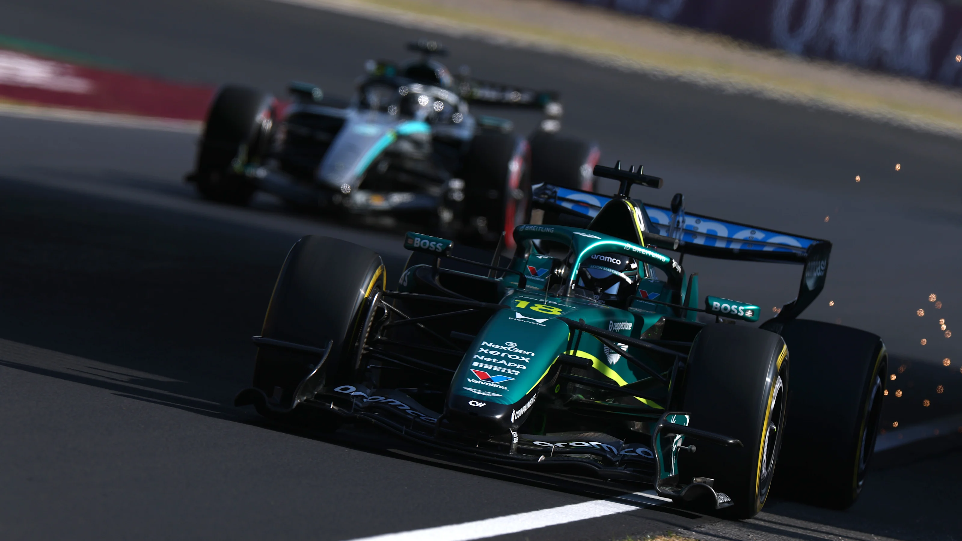 SUZUKA, JAPAN - MARCH 27: Sparks fly behind Lance Stroll of Canada driving the (18) Aston Martin F1