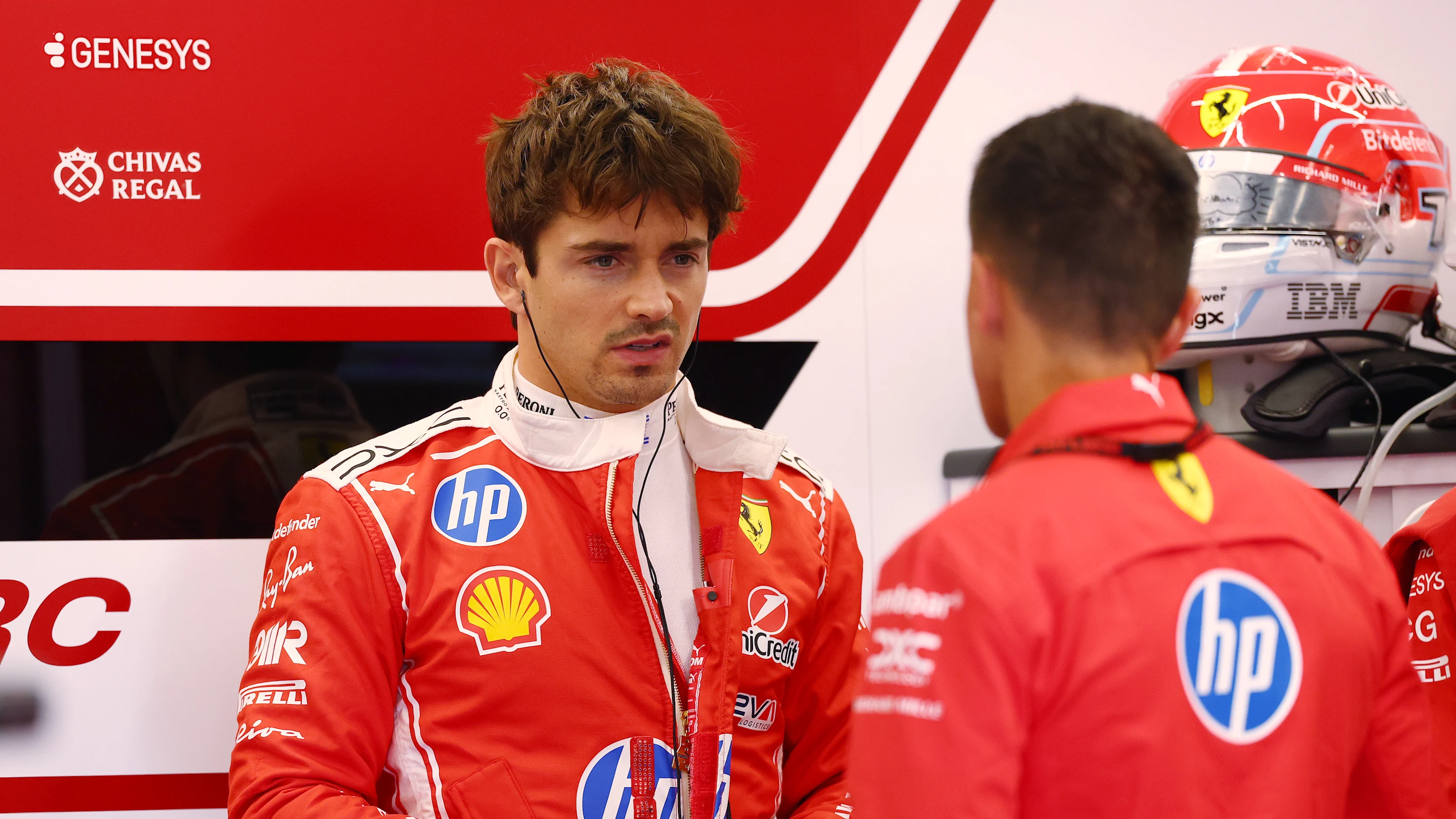 SPA, BELGIUM - JULY 17: Charles Leclerc of Monaco and Scuderia Ferrari talks in the garage during
