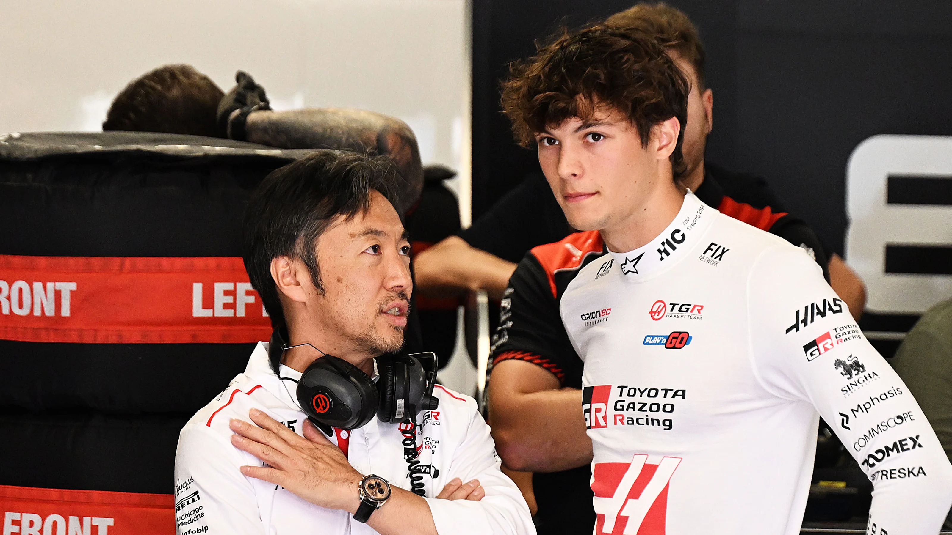 BUDAPEST, HUNGARY - JULY 25: Ayao Komatsu, Team Principal of Haas F1 and Oliver Bearman of Great