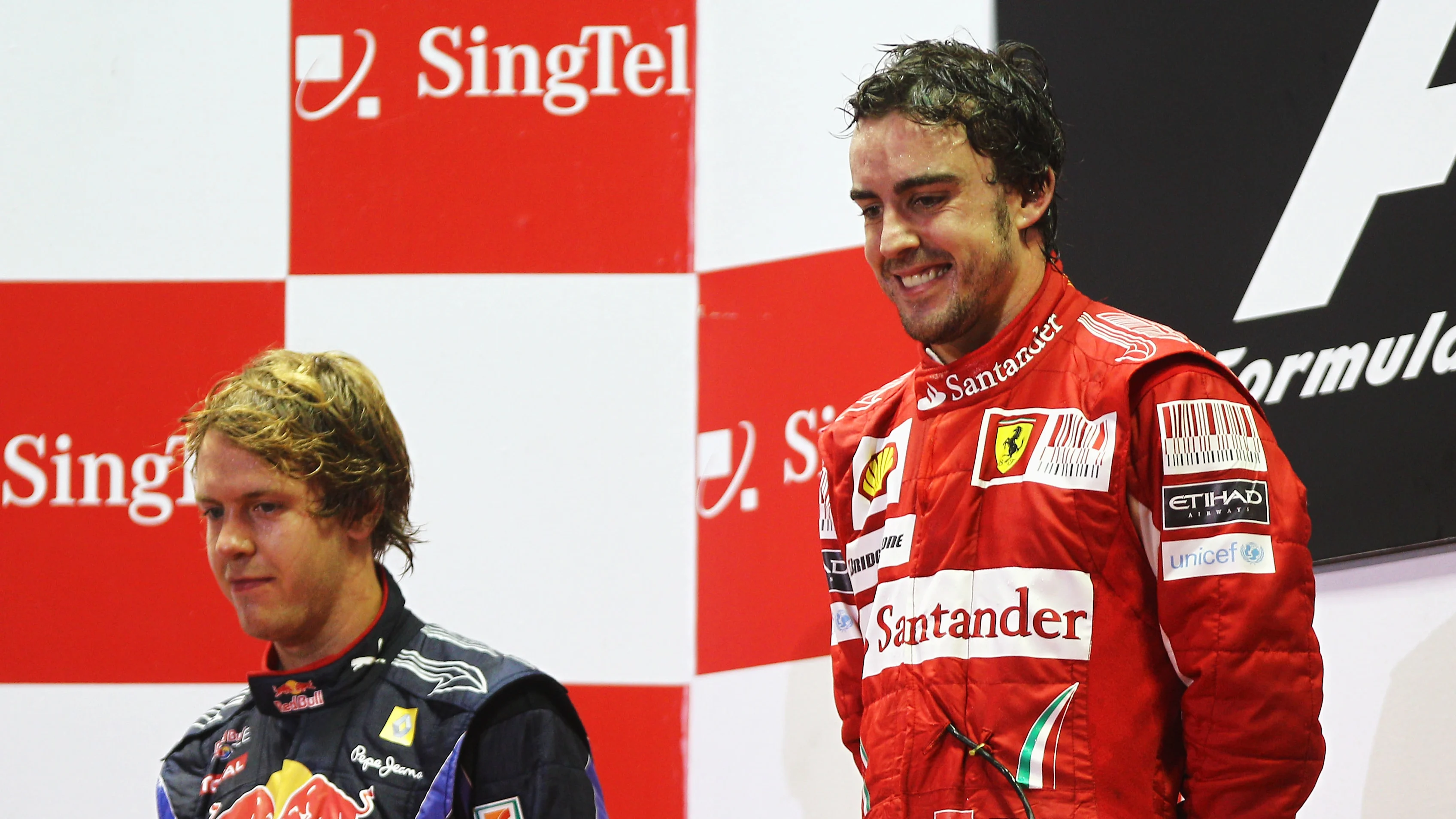 SINGAPORE - SEPTEMBER 26: Race winner Fernando Alonso (R) of Spain and Ferrari celebrates on the