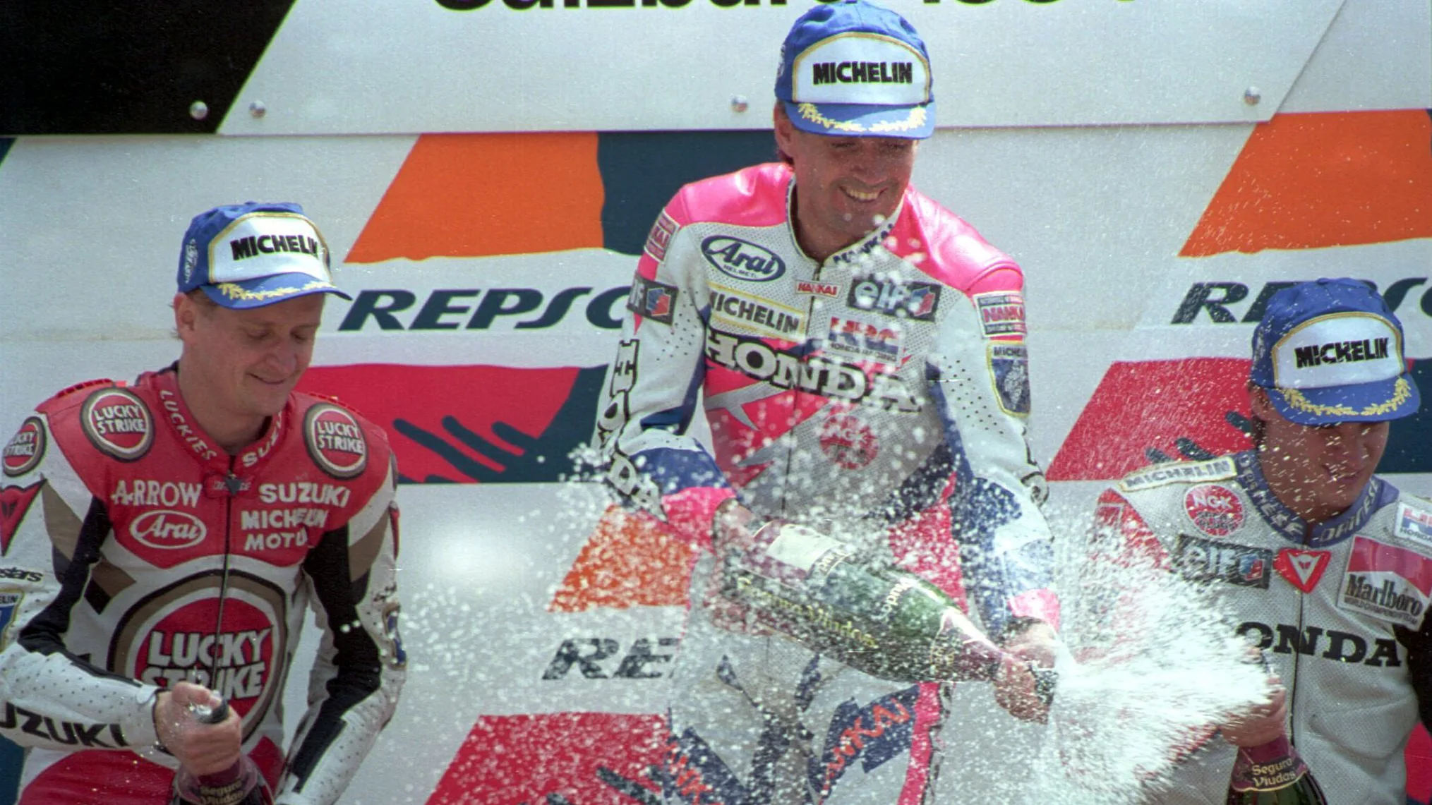 22 MAY 1994: AUSTRIAN 500CC GRAND PRIX WINNER MICK DOOHAN OF AUSTRALIA, CENTRE, CELEBRATES HIS WIN