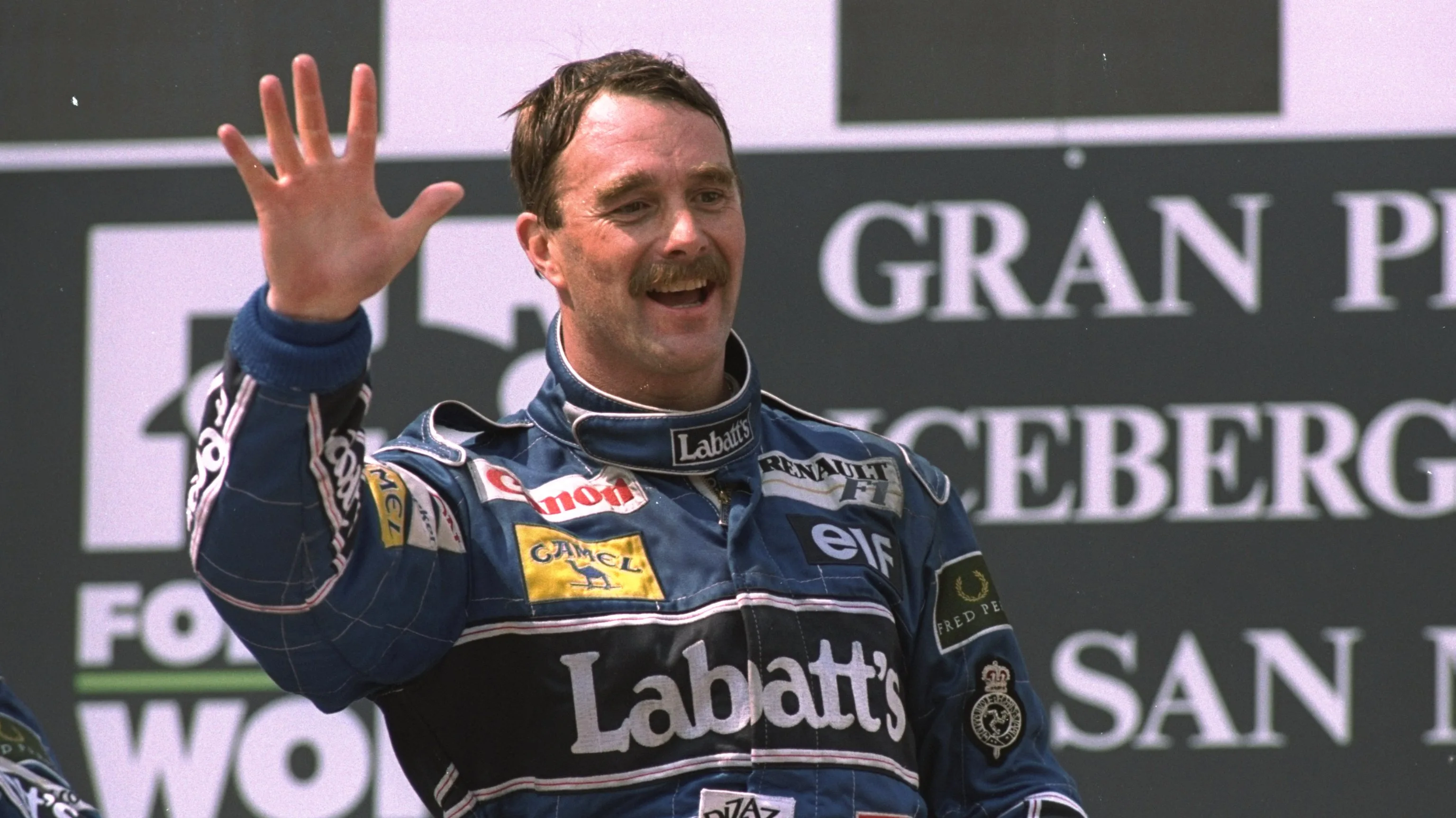 1992: Williams Renault driver Nigel Mansell of Great Britain waves to the crowd as he stands on