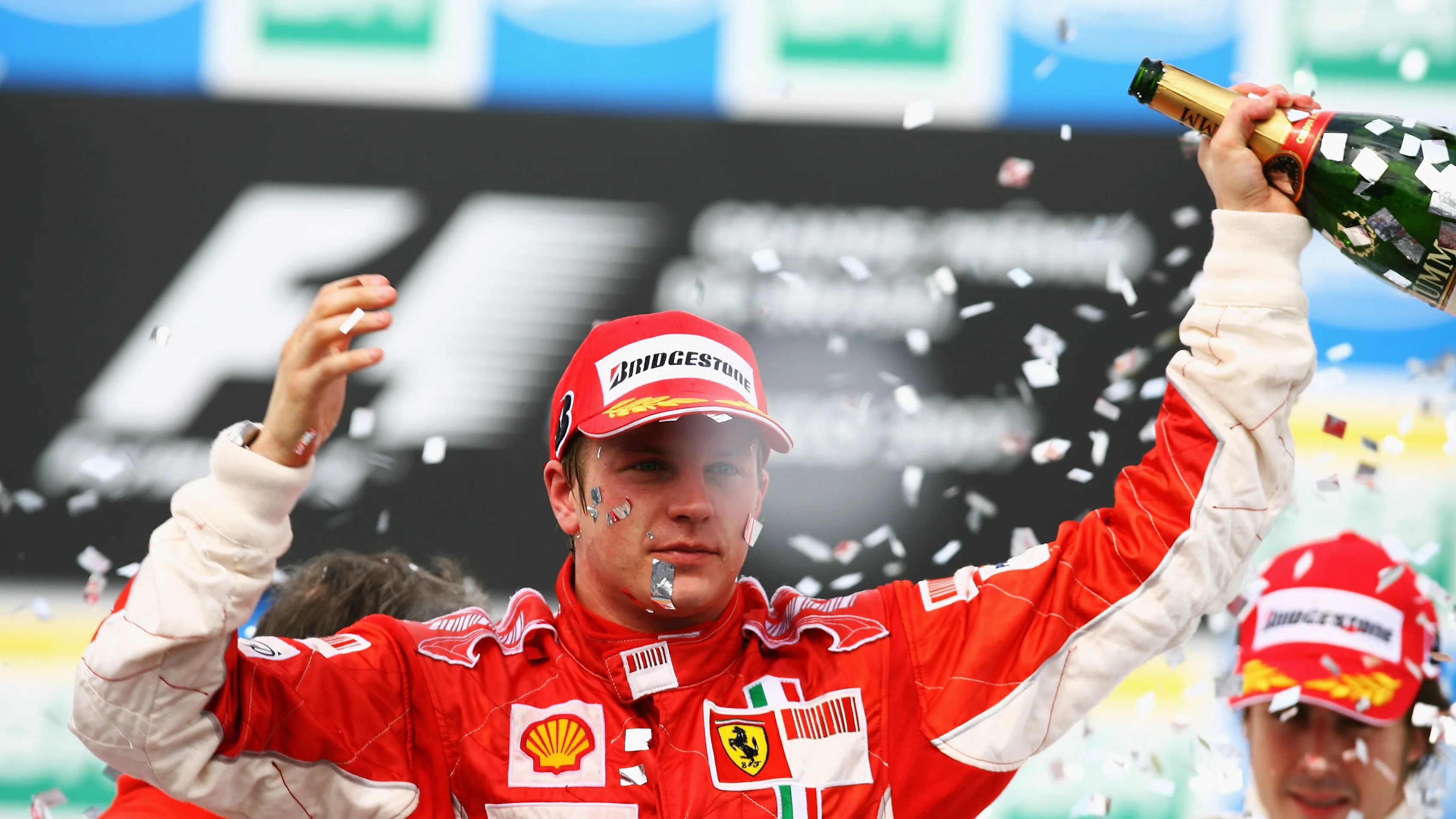 SAO PAULO, BRAZIL - OCTOBER 21: Kimi Raikkonen of Finland and Ferrari celebrates on the podium