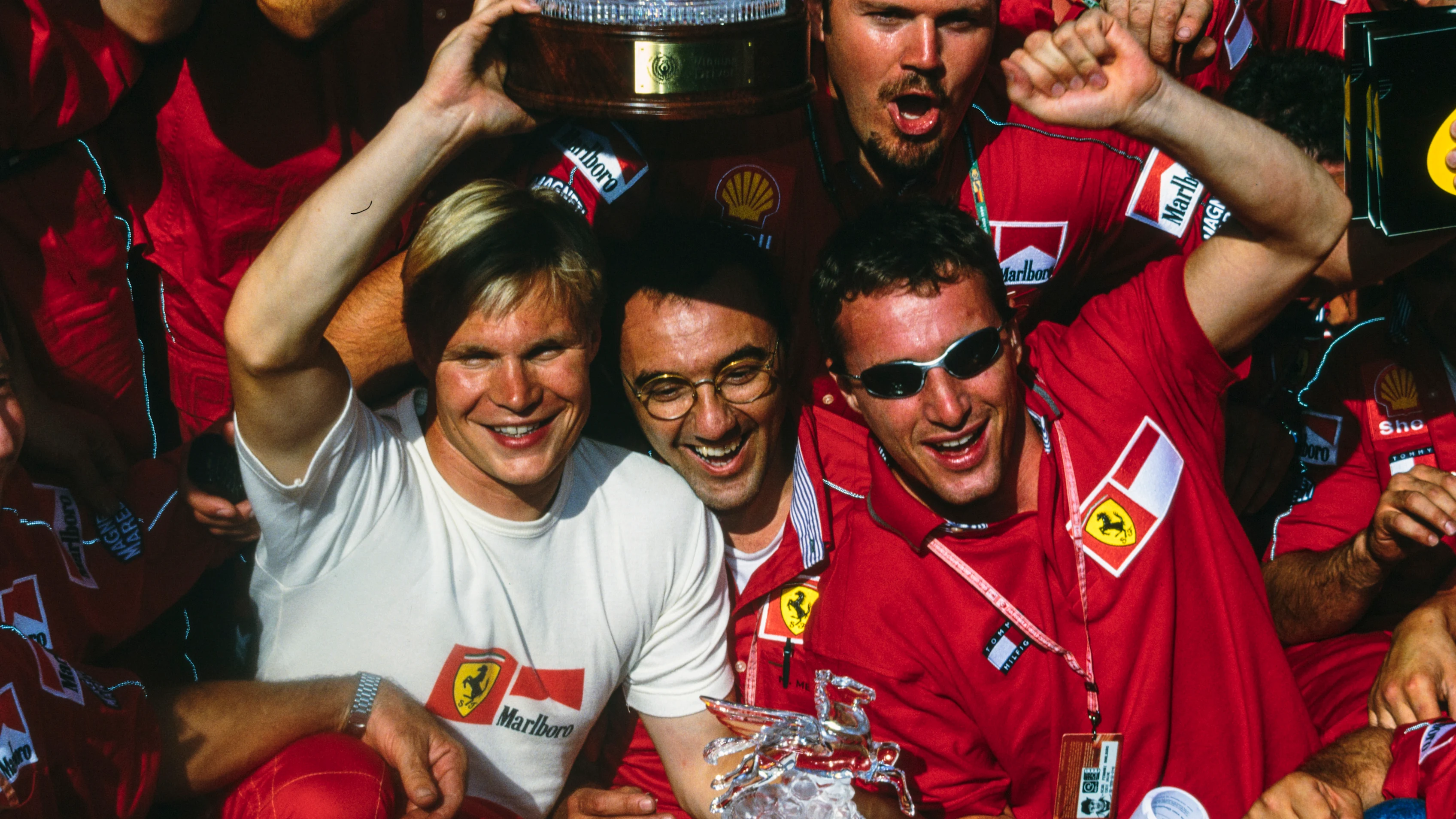 HOCKENHEIMRING, GERMANY - AUGUST 01: Mika Salo, Eddie Irvine, and the Ferrari team celebrate a 1-2