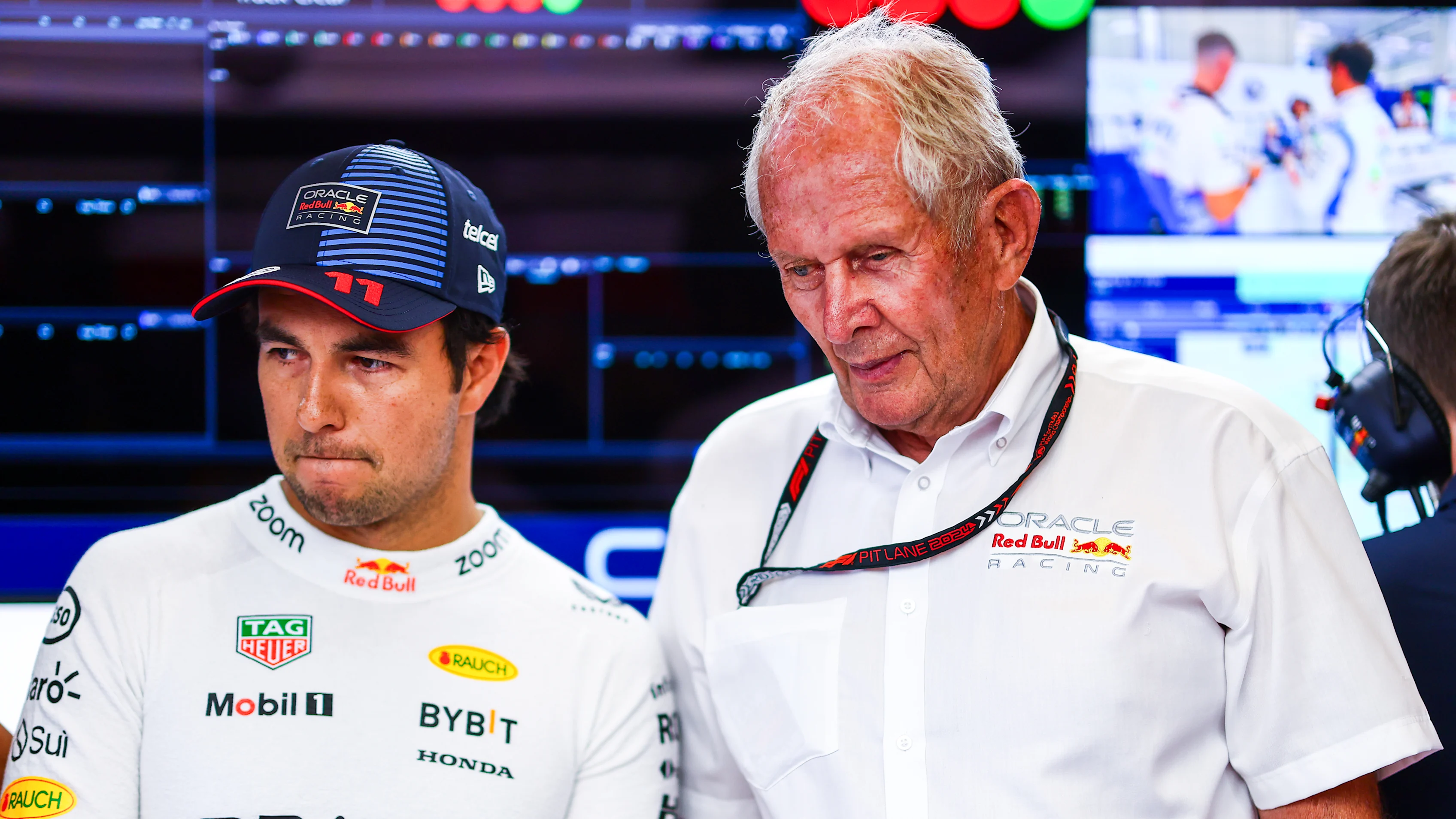 SPIELBERG, AUSTRIA - JUNE 28: Sergio Perez of Mexico and Oracle Red Bull Racing and Oracle Red Bull Racing Team Consultant Dr Helmut Marko look on in the garage prior to Sprint Qualifying. (Photo by Mark Thompson/Getty Images)
