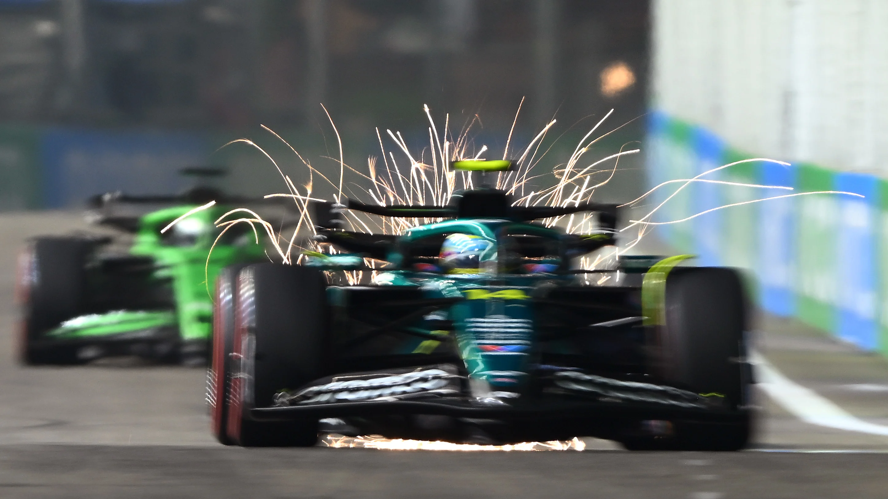 SINGAPORE, SINGAPORE - OCTOBER 04: Sparks fly behind Fernando Alonso of Spain driving the (14)