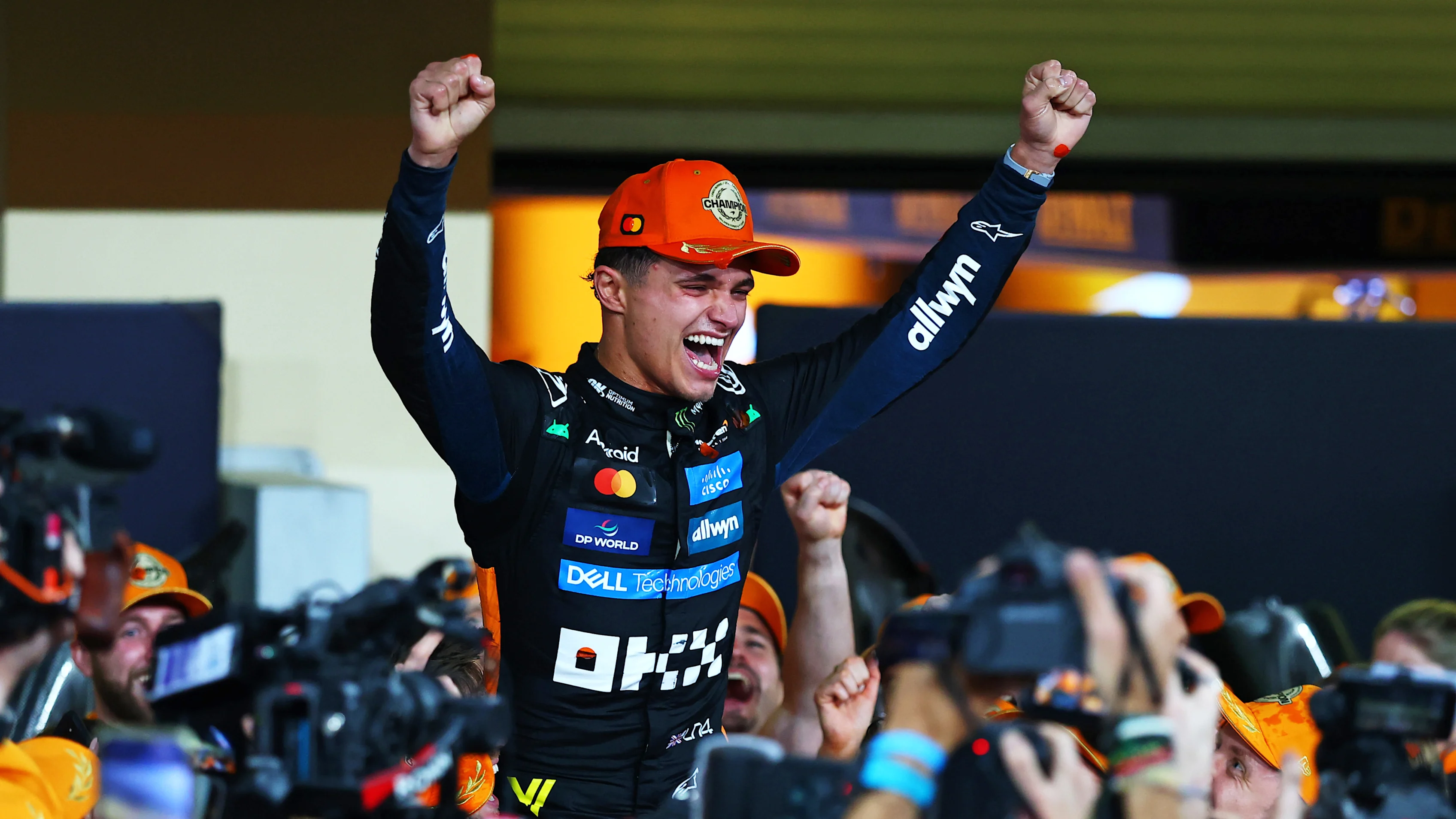 ABU DHABI, UNITED ARAB EMIRATES - DECEMBER 07: 2025 F1 World Drivers Champion Lando Norris of Great Britain and McLaren celebrates with his team during the F1 Grand Prix of Abu Dhabi at Yas Marina Circuit on December 07, 2025 in Abu Dhabi, United Arab Emirates. (Photo by Bryn Lennon - Formula 1/Formula 1 via Getty Images)