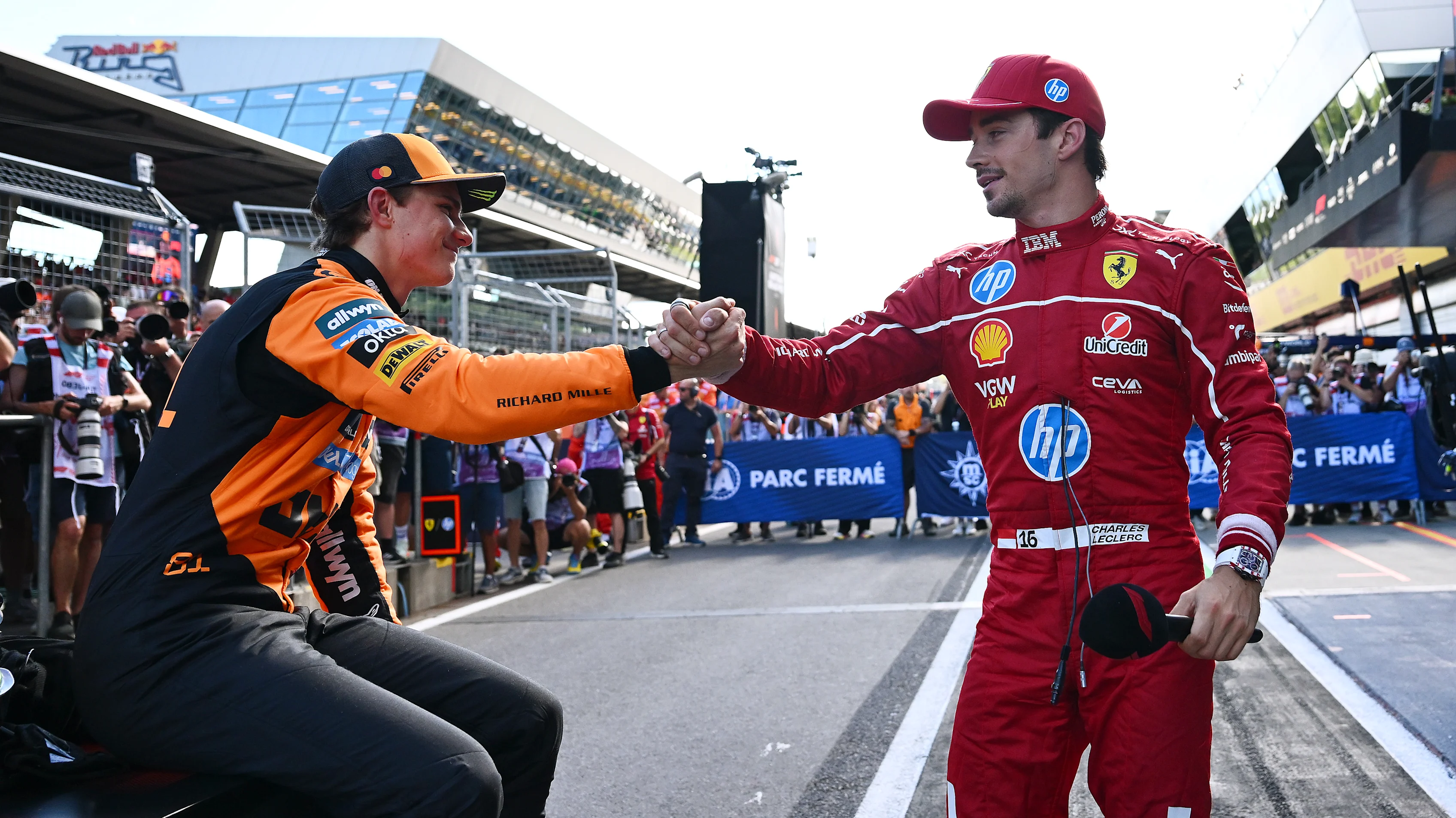SPIELBERG, AUSTRIA - JUNE 28: Second placed qualifier Charles Leclerc of Monaco and Scuderia Ferrari and Third placed qualifier Oscar Piastri of Australia and McLaren congratulate each other in parc ferme during qualifying ahead of the F1 Grand Prix of Austria at Red Bull Ring on June 28, 2025 in Spielberg, Austria. (Photo by Mark Sutton - Formula 1/Formula 1 via Getty Images)