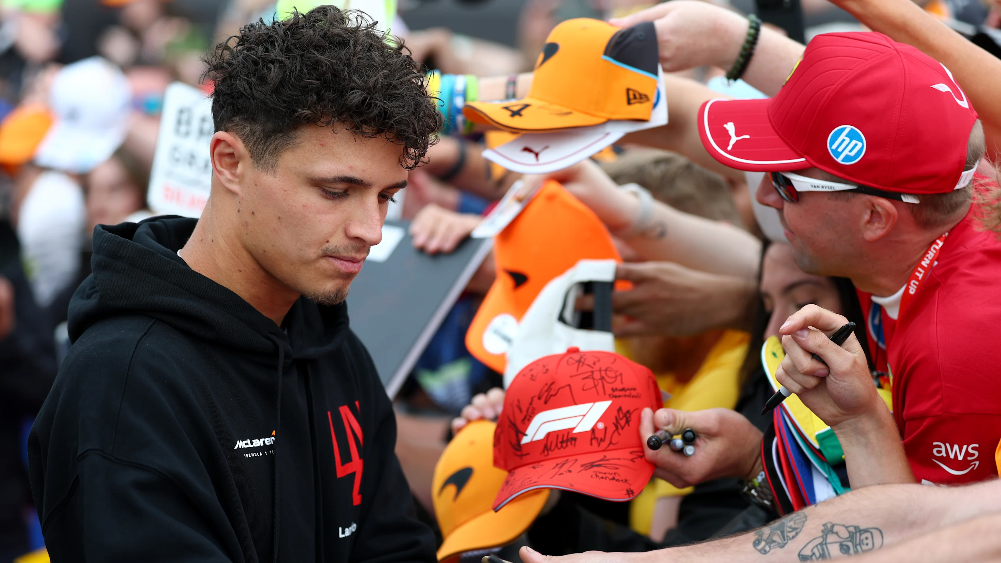 NORTHAMPTON, ENGLAND - JULY 04: Lando Norris of Great Britain and McLaren signs autographs for fans