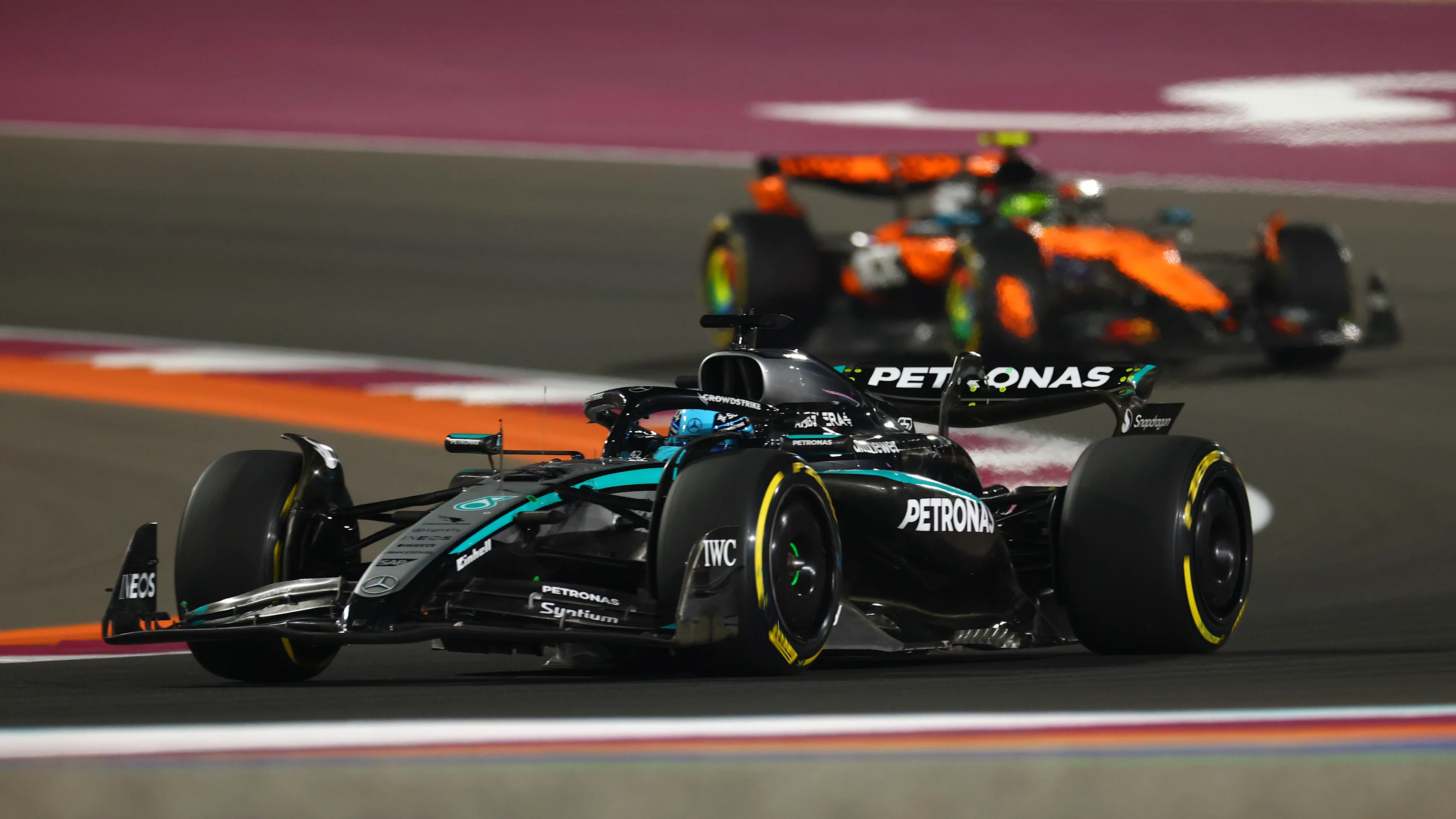 LUSAIL CITY, QATAR - NOVEMBER 29: George Russell of Great Britain driving the (63) Mercedes AMG Petronas F1 Team W16 leads Lando Norris of Great Britain driving the (4) McLaren MCL39 Mercedes on track during the Sprint ahead of the F1 Grand Prix of Qatar at Lusail International Circuit on November 29, 2025 in Lusail City, Qatar. (Photo by Clive Rose - Formula 1/Formula 1 via Getty Images)