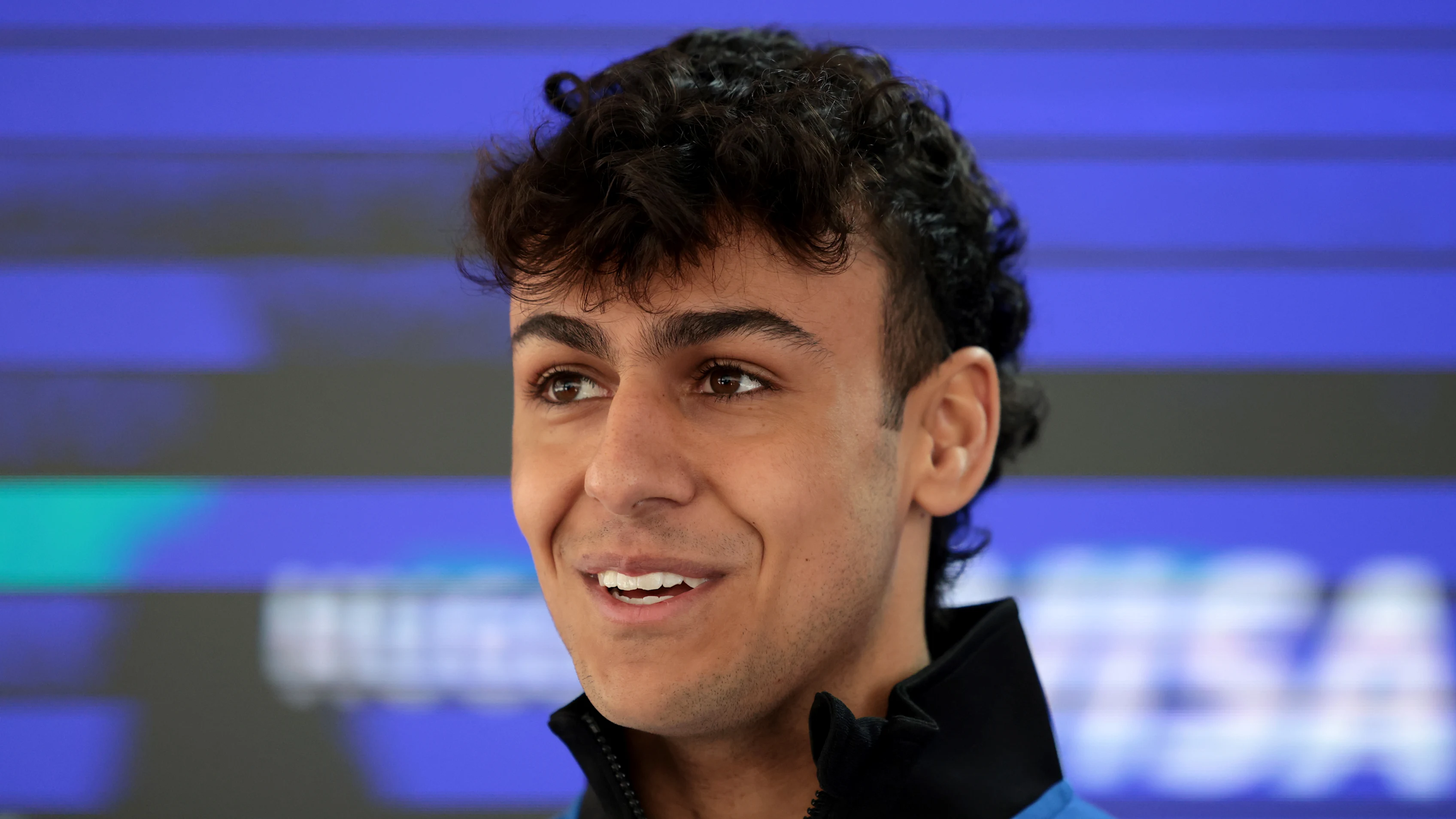 SHANGHAI, CHINA - MARCH 12: Arvid Lindblad of Great Britain and Visa Cash App Racing Bulls talks to