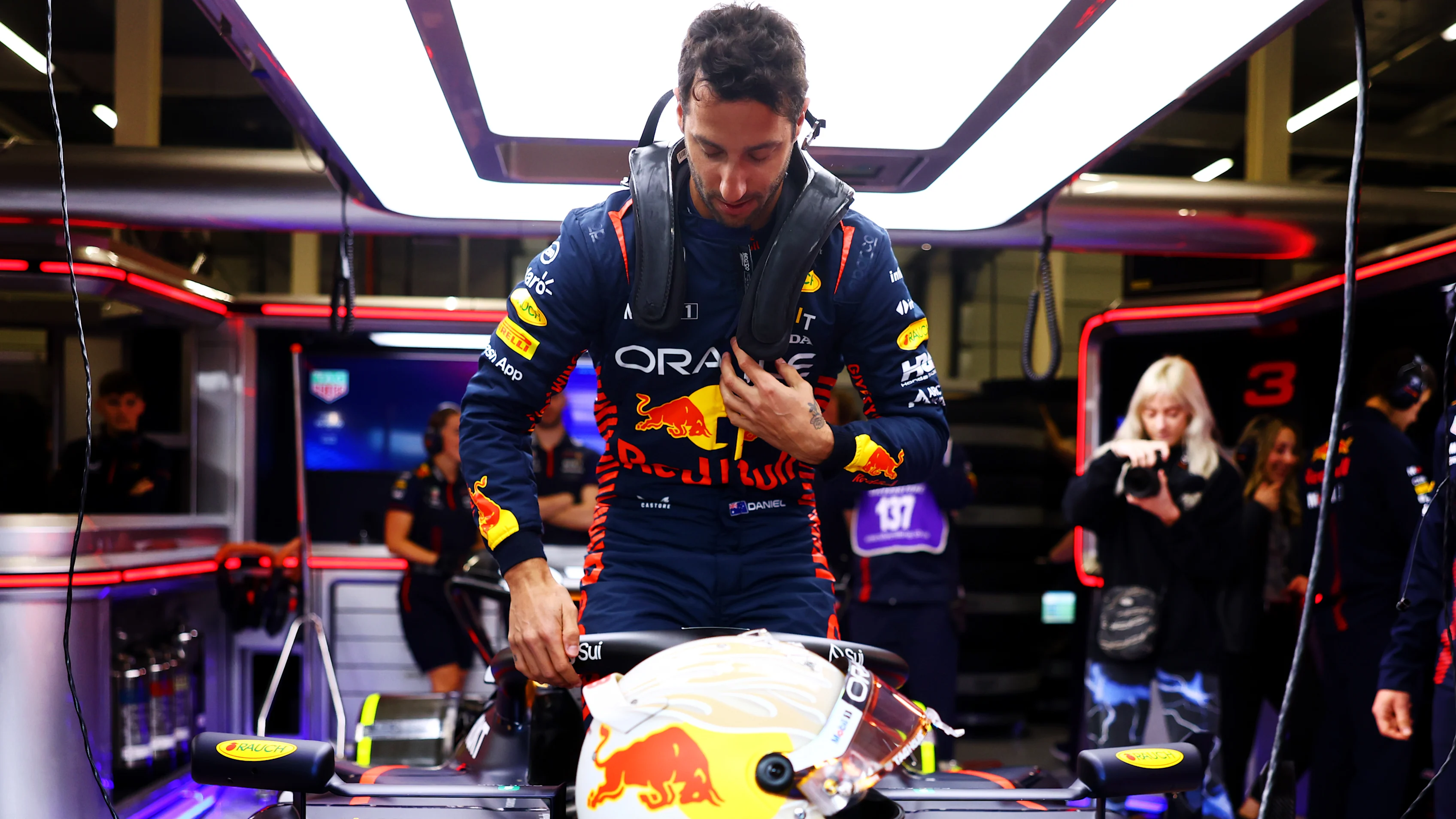 NORTHAMPTON, ENGLAND - JULY 11:  Daniel Ricciardo of Australia climbs into the (3) Oracle Red Bull
