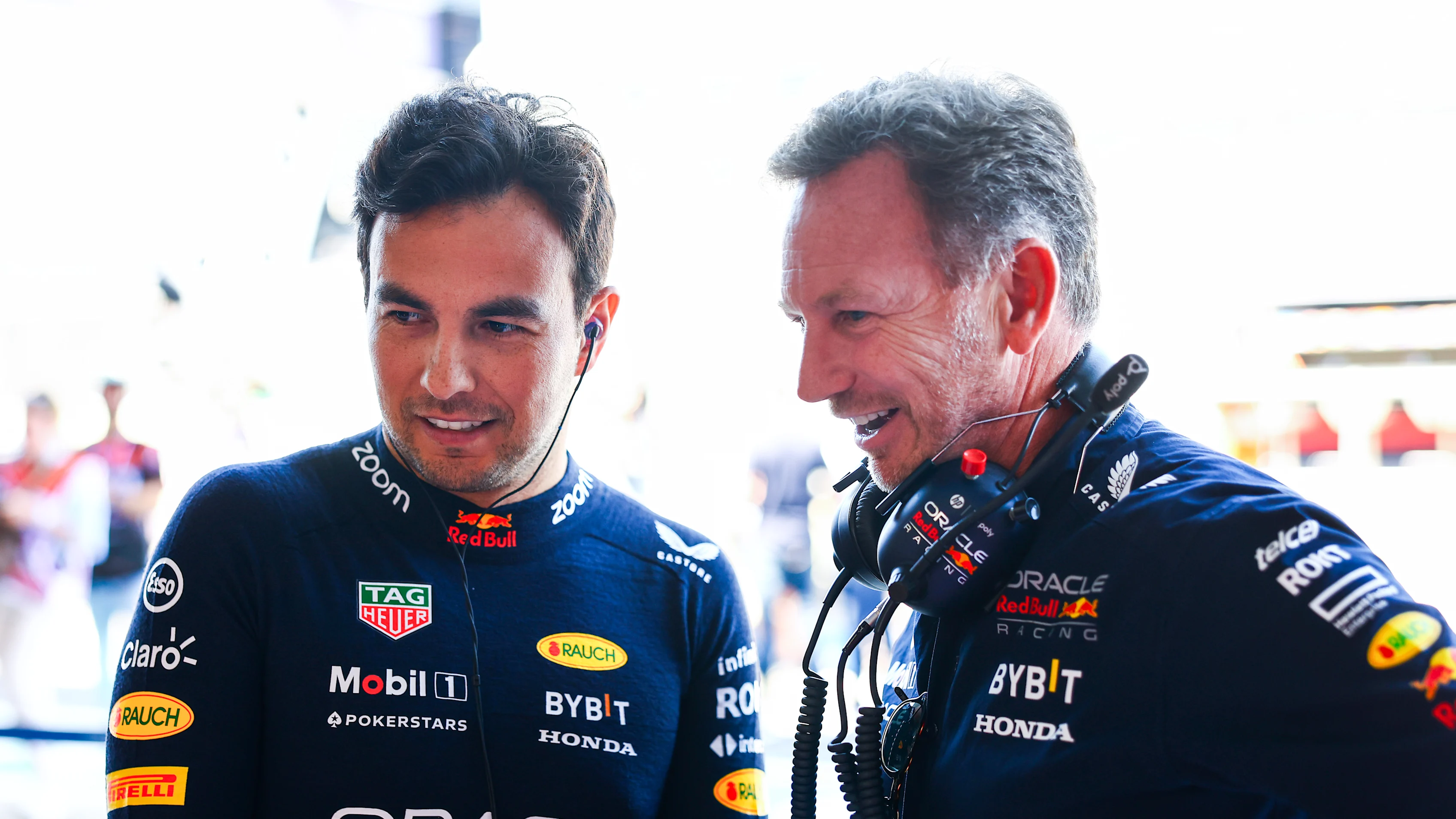 NORTHAMPTON, ENGLAND - JULY 07: Sergio Perez of Mexico and Oracle Red Bull Racing talks with Red