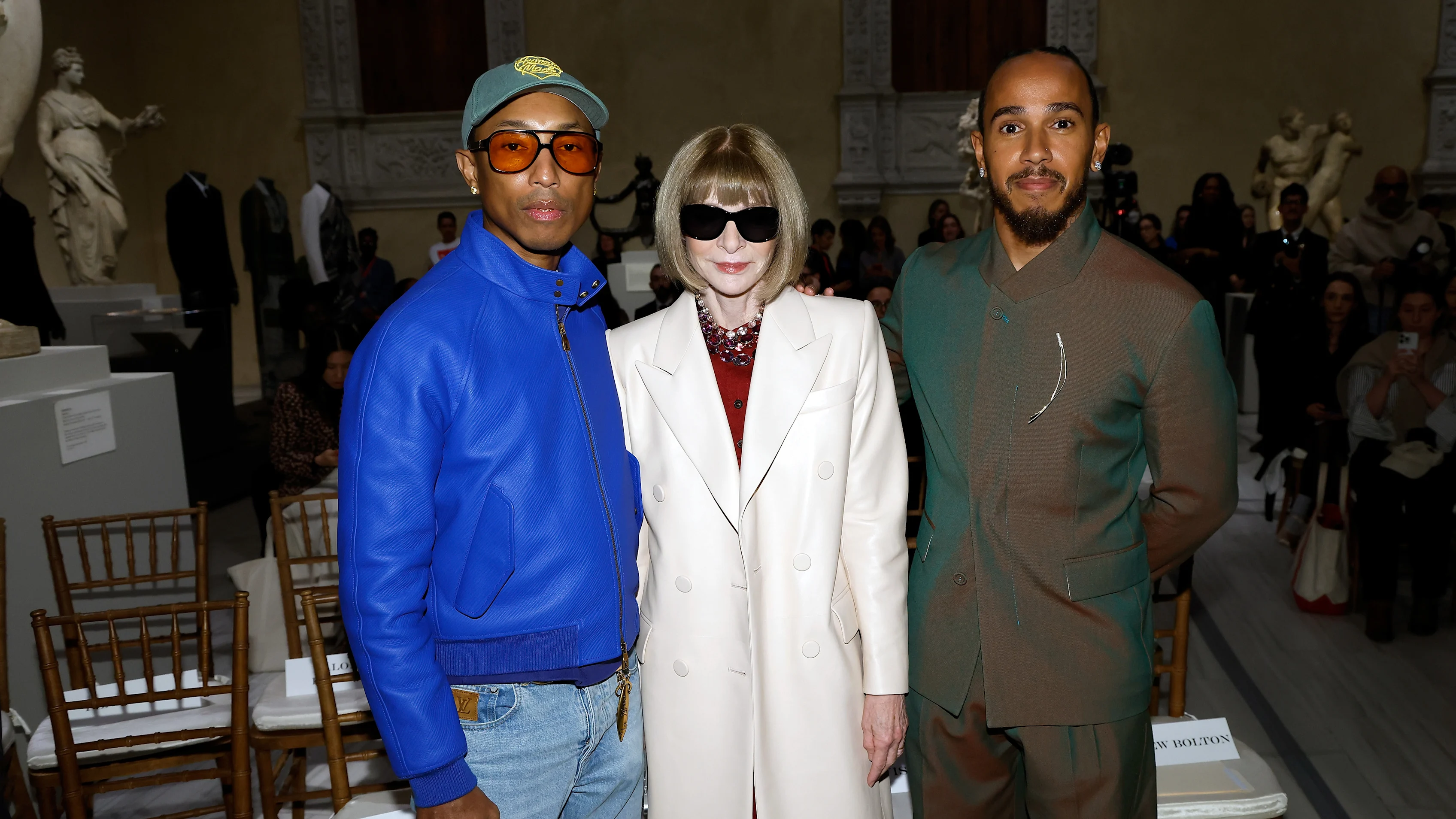 NEW YORK, NEW YORK - OCTOBER 09: Pharrell Williams, Anna Wintour, and Lewis Hamilton attend a press