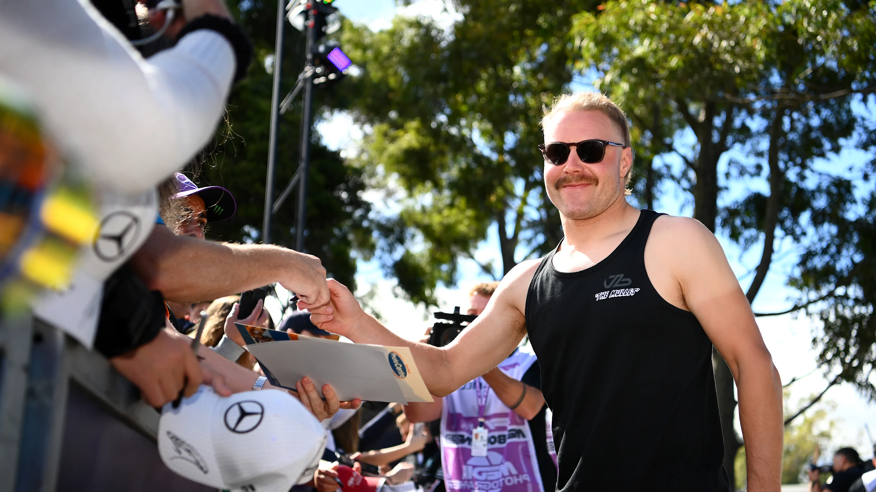 MELBOURNE, AUSTRALIA - MARCH 30: Valtteri Bottas of Finland and Alfa Romeo F1 greets fans at the