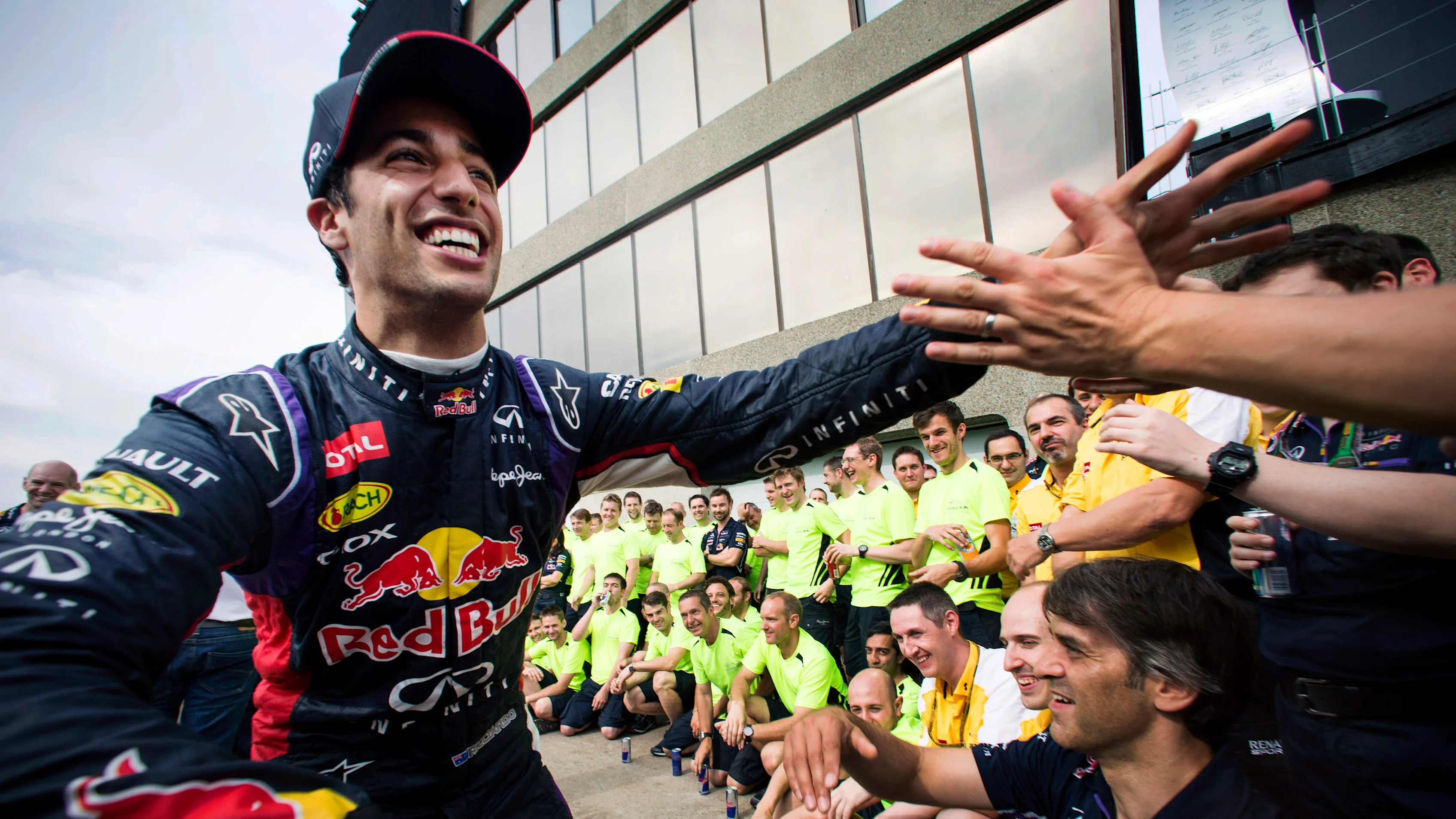 Smiling Australian Red Bull Racing Formula One racing team racing driver Daniel Ricciardo giving