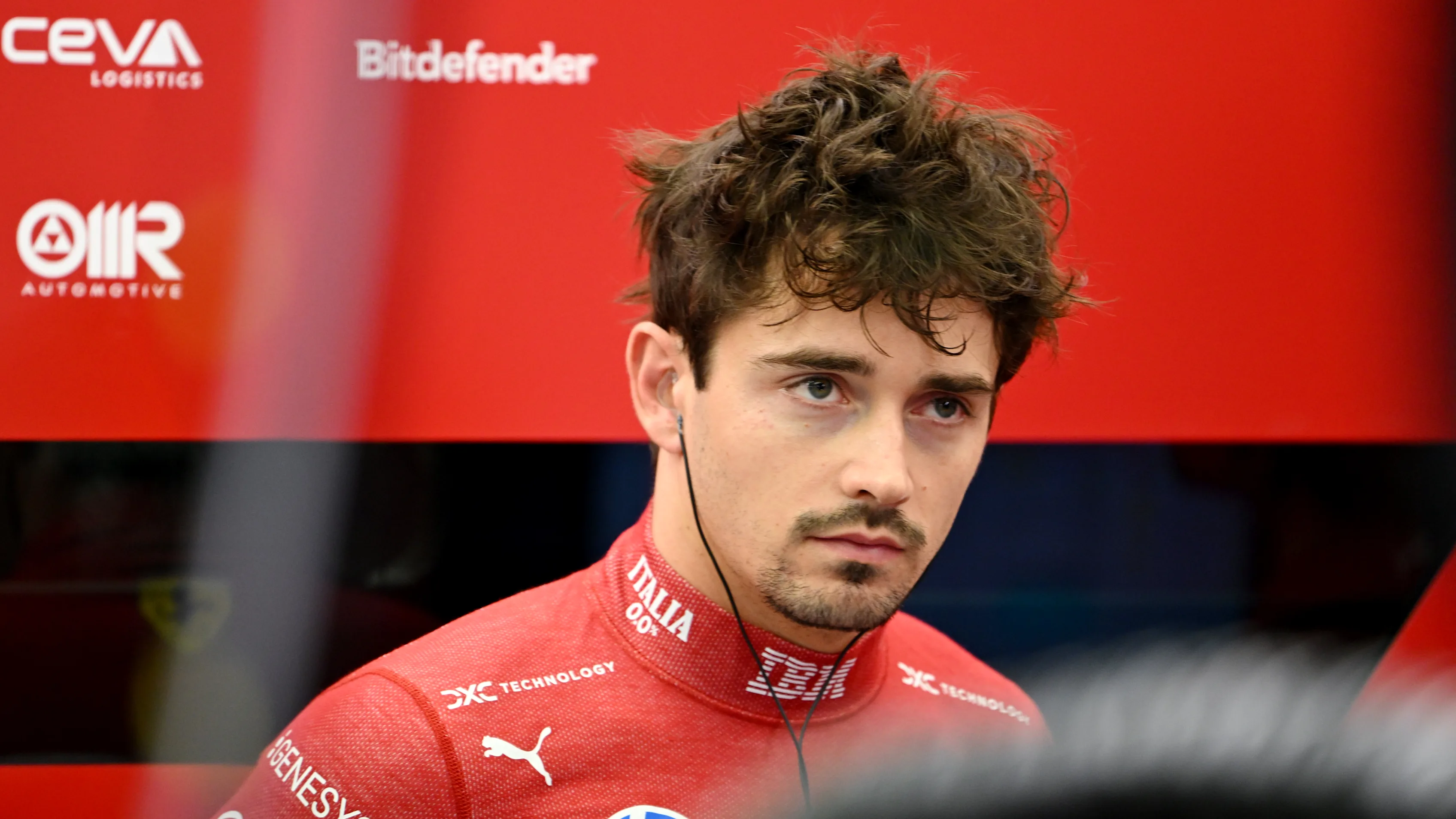 BAHRAIN, BAHRAIN - APRIL 11: Charles Leclerc of Monaco and Scuderia Ferrari looks on in the garage