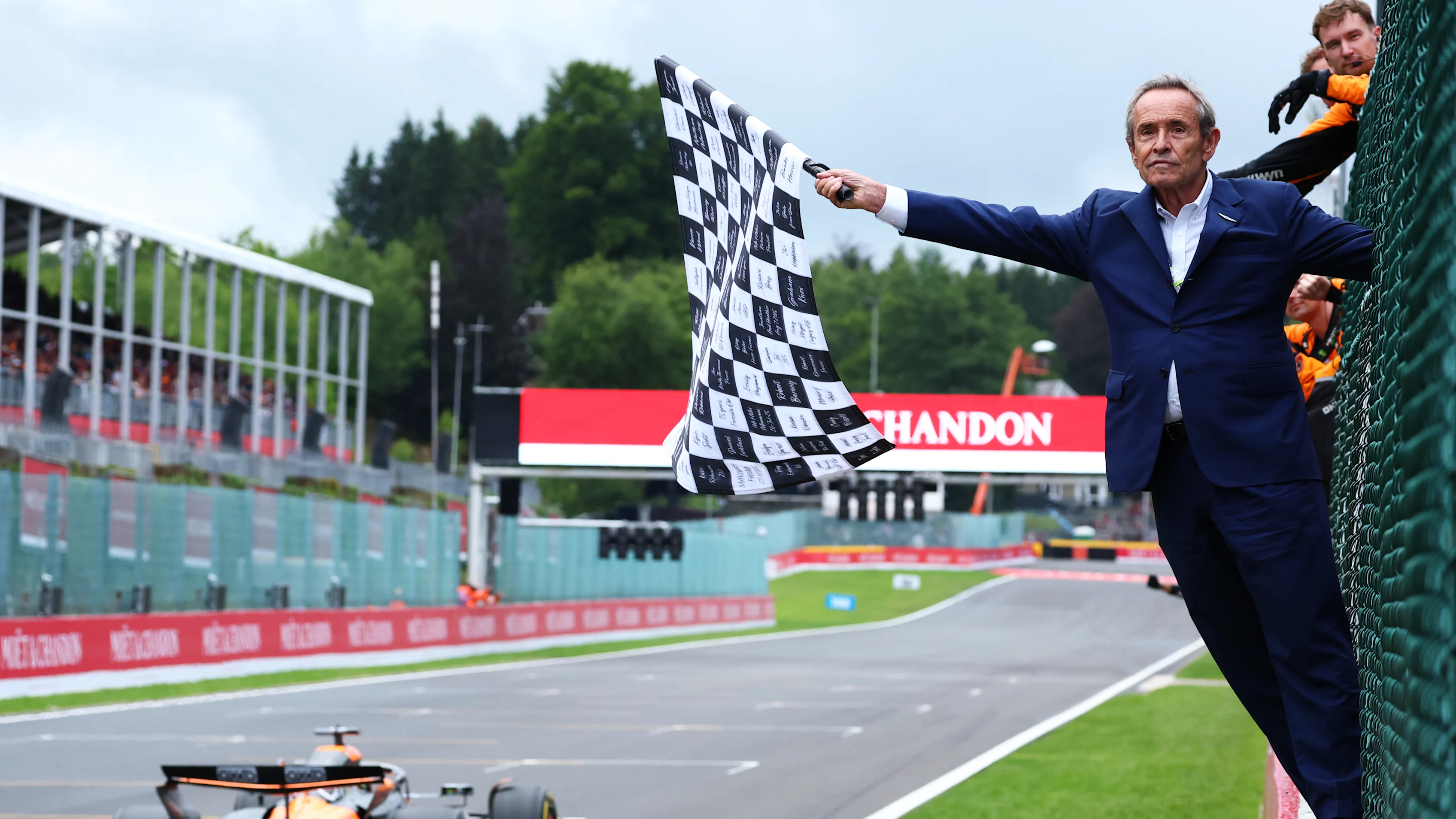 SPA, BELGIUM - JULY 27: Jacky Ickx waves the chequered flag for Race winner Oscar Piastri of