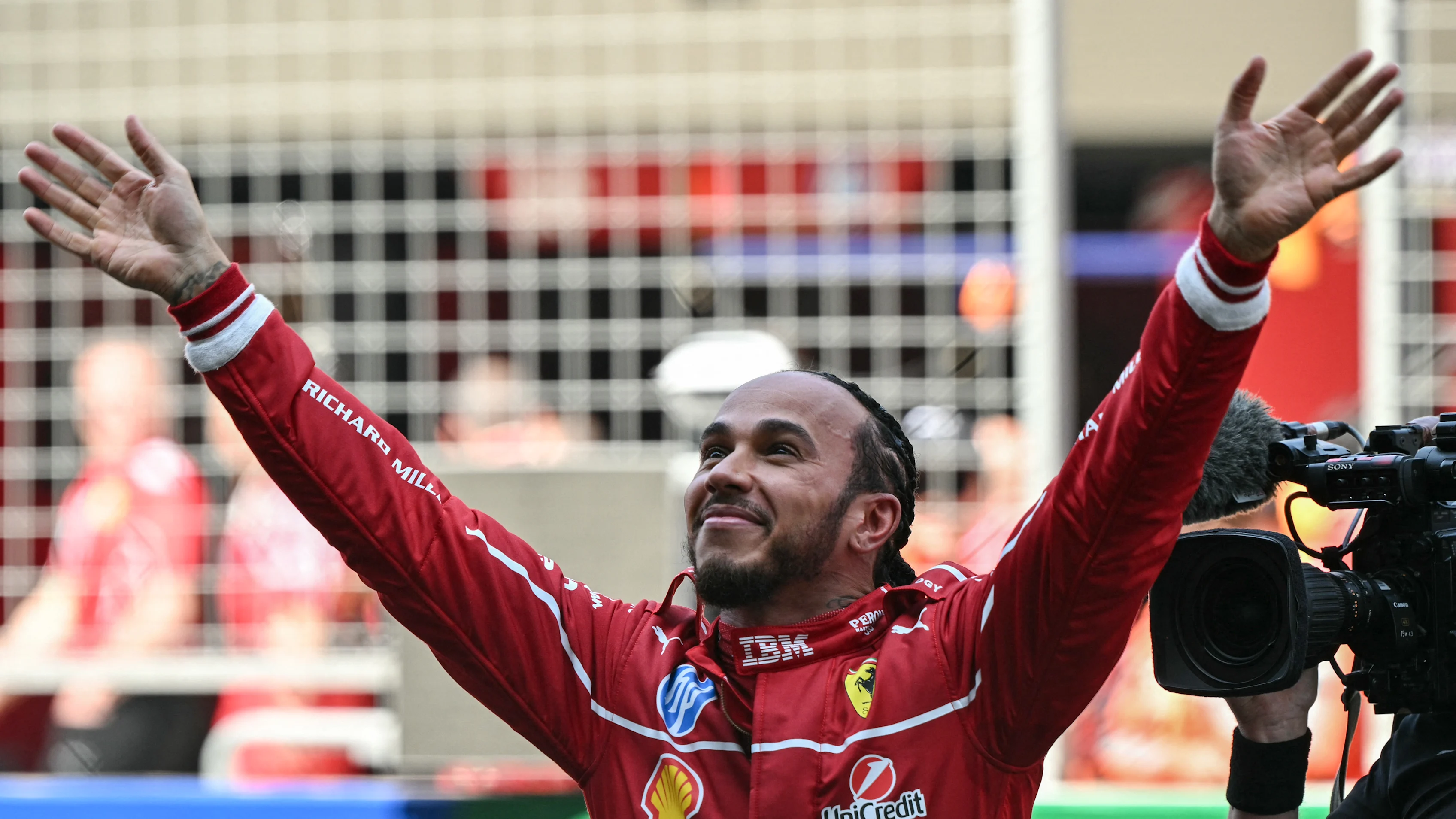 Ferrari's British driver Lewis Hamilton celebrates winning the sprint race of the Formula One