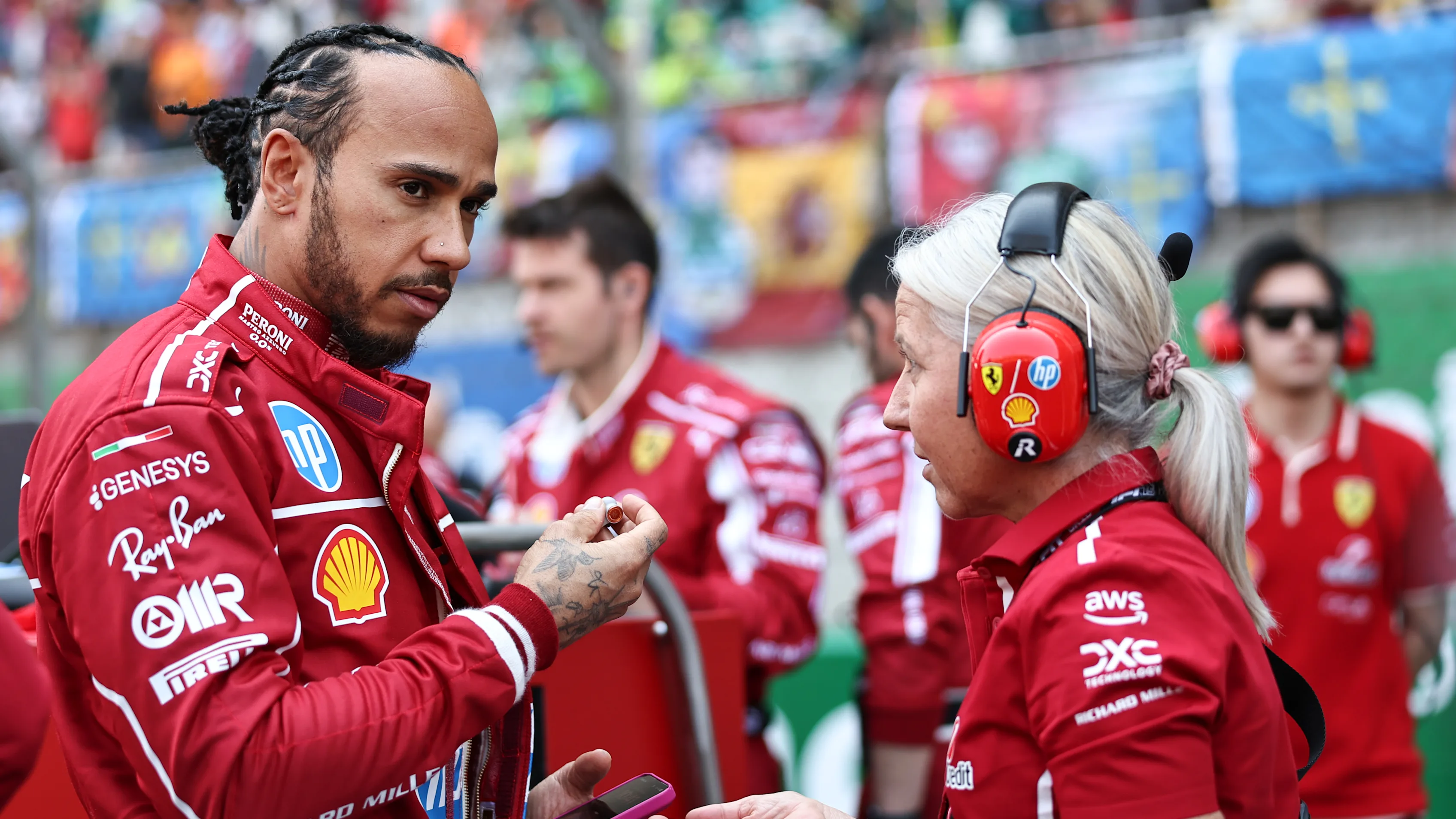 Lewis Hamilton of Great Britain and Scuderia Ferrari talks with his physio Angela Cullen during the