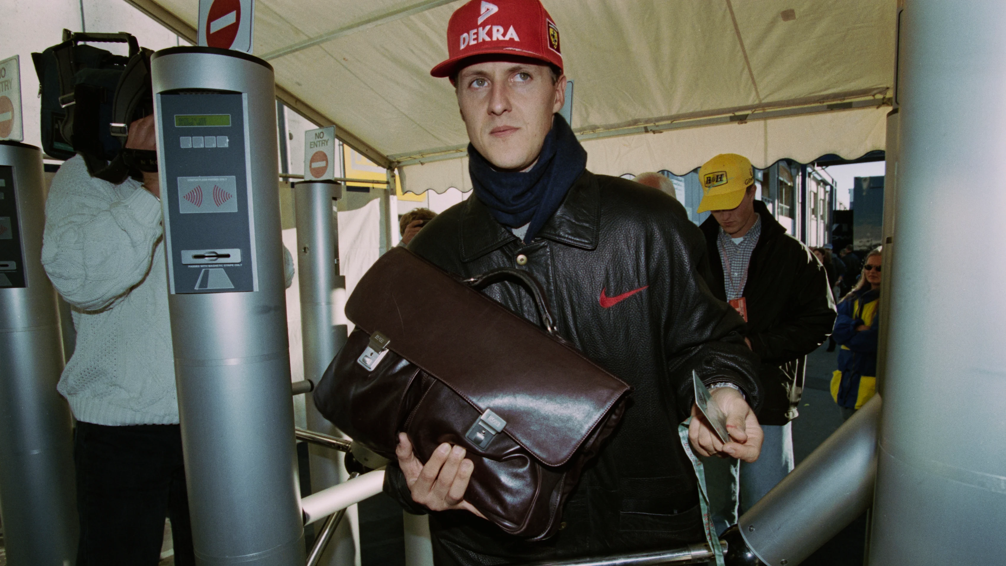 German racing driver Michael Schumacher, wearing a red DEKRA baseball cap, with a scarf and a black