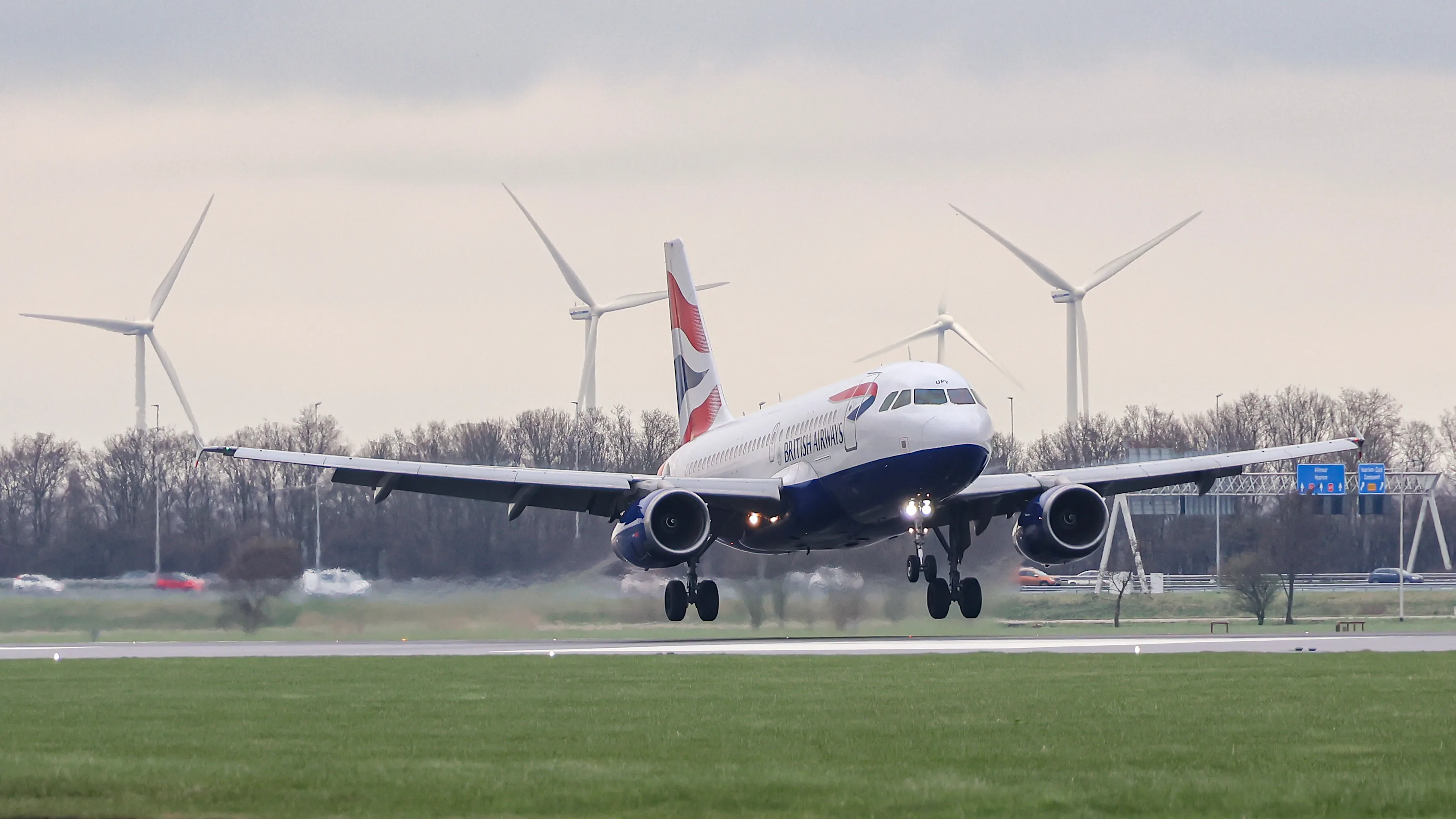 British Airways Airbus A319 passenger aircraft flying and landing at Polderbaan runway of Amsterdam