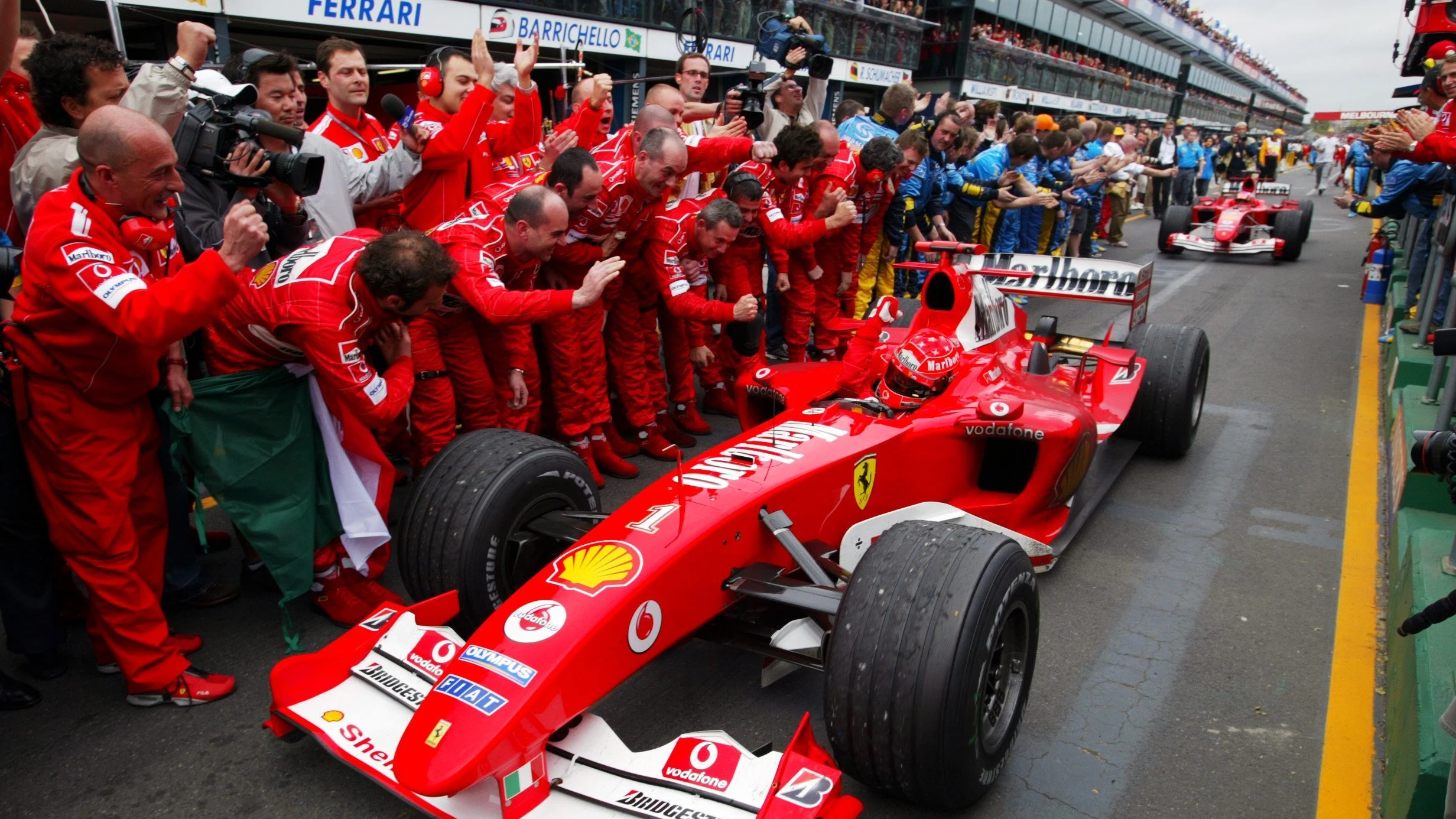 Michael Schumacher (GER) Ferrari F2004 celebrates his victory as he enters the Parc Ferme.