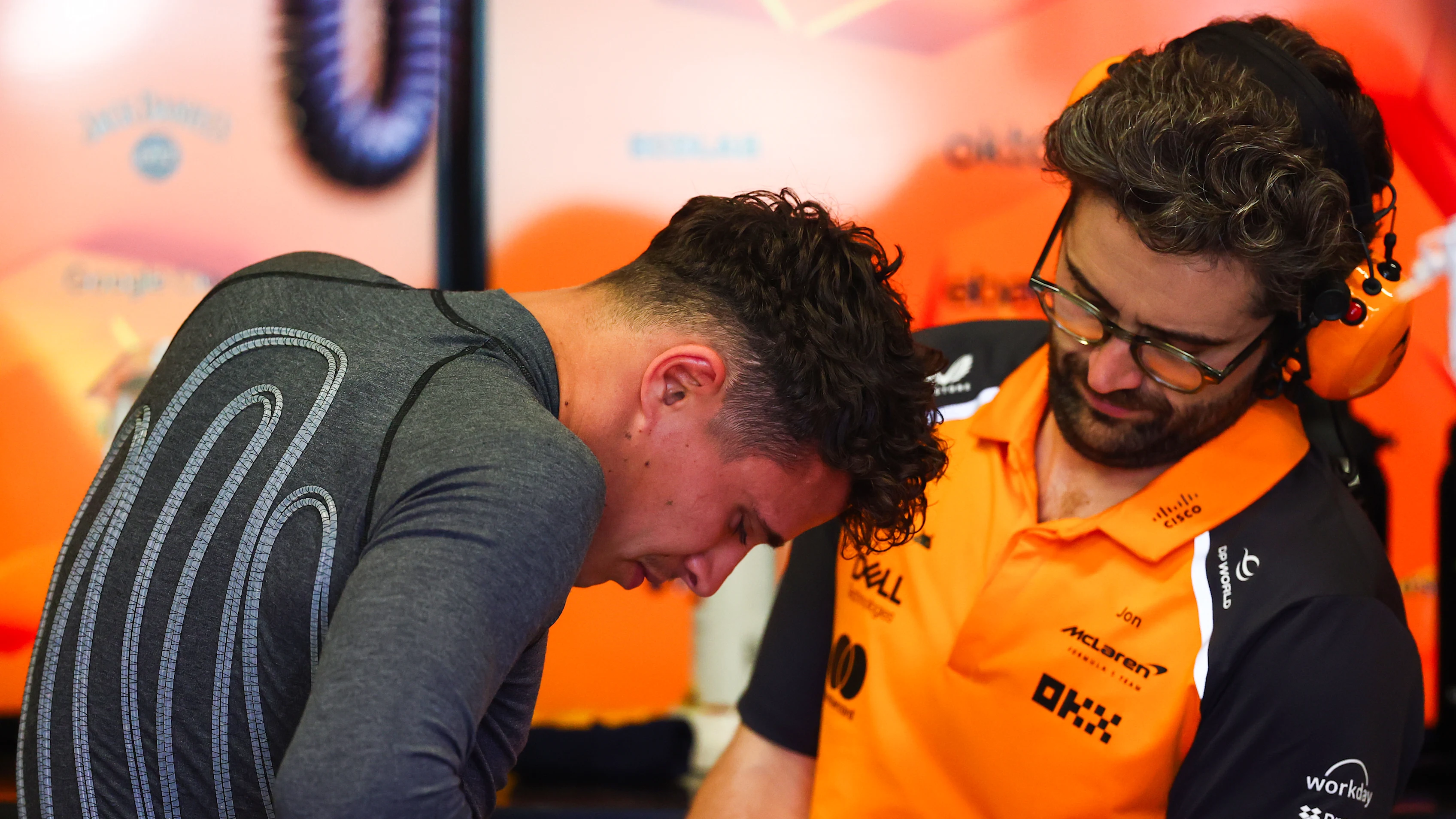 BARCELONA, SPAIN - MAY 30: Lando Norris of Great Britain and McLaren attaches a cooling vest in the