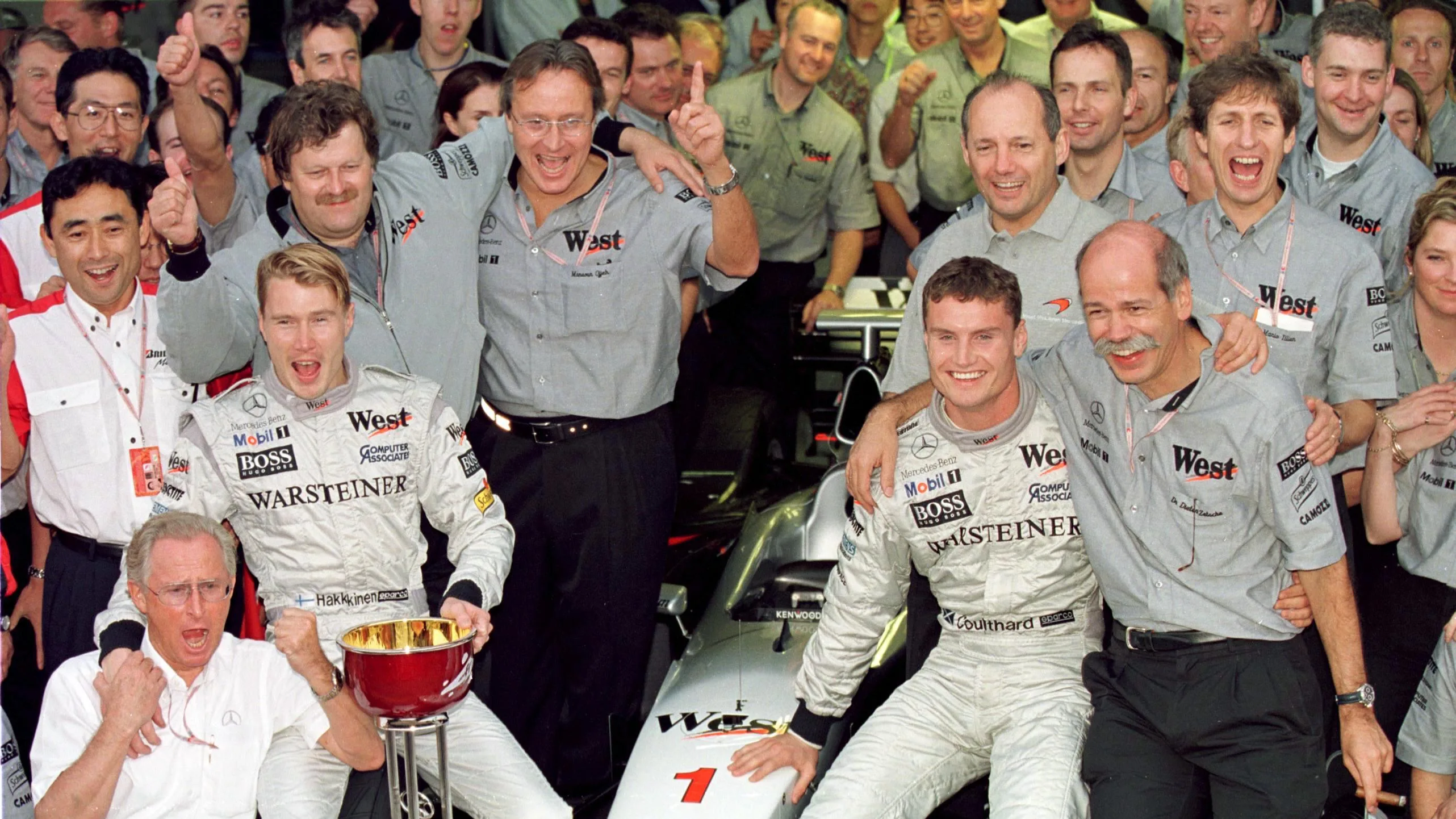 01/11/98 - Japanese Grand Prix.Mika Hakkinen and David Coulthard celebrate with the Mercedes