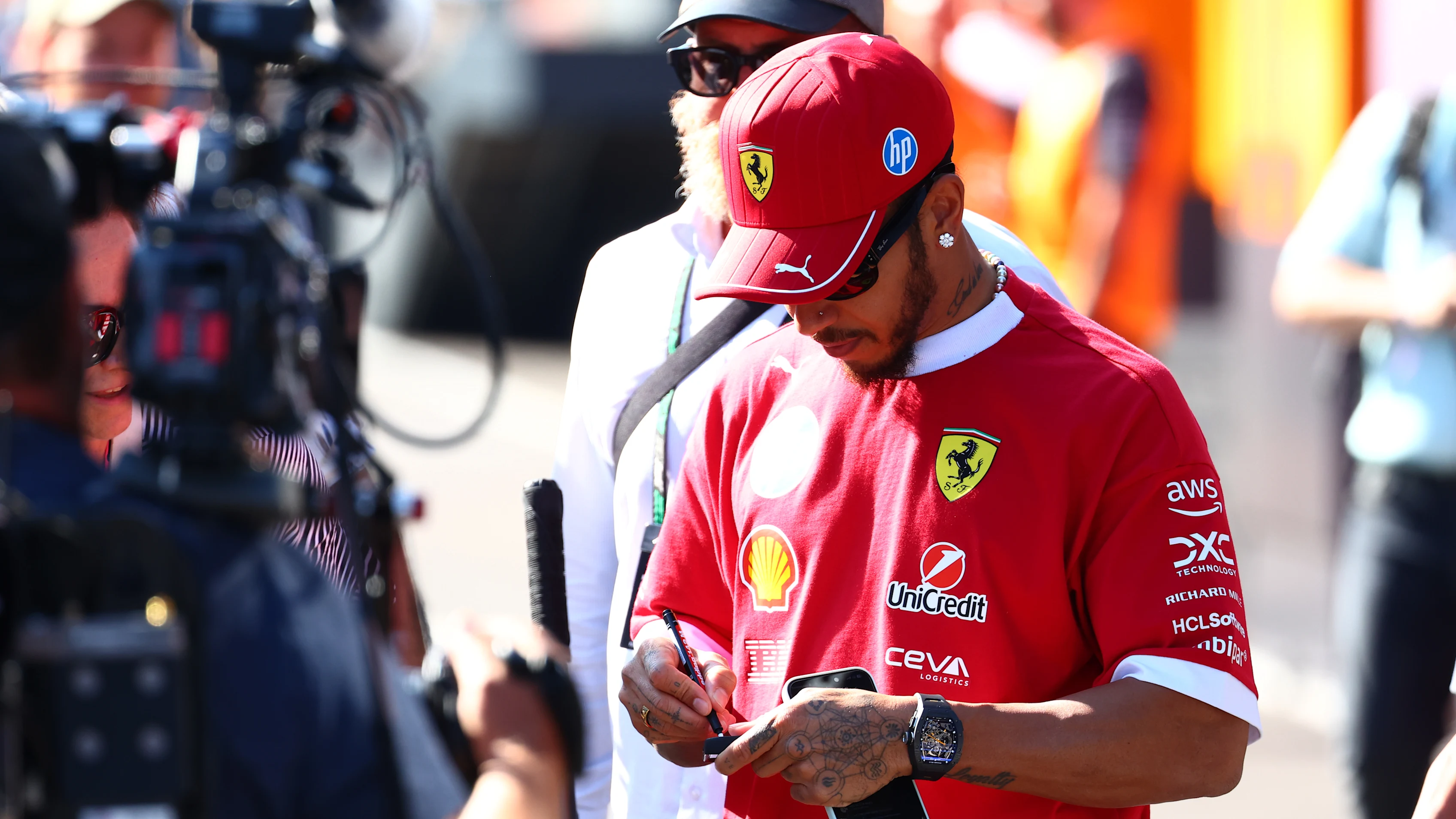 BUDAPEST, HUNGARY - JULY 31: Lewis Hamilton of Great Britain and Scuderia Ferrari signs autographs