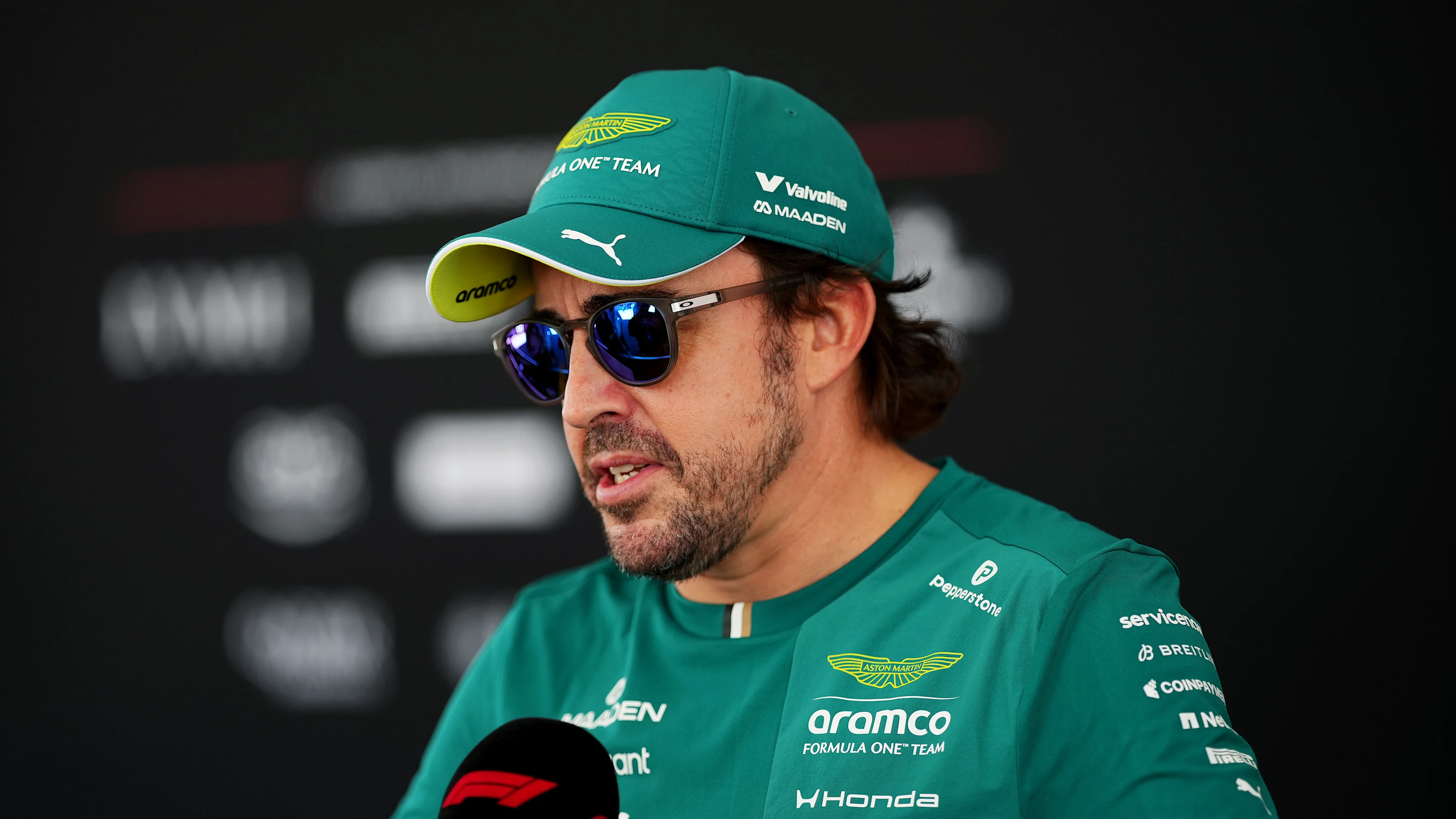 KUALA LUMPUR, MALAYSIA - OCTOBER 01: Fernando Alonso of Spain and Aston Martin F1 Team talks to the