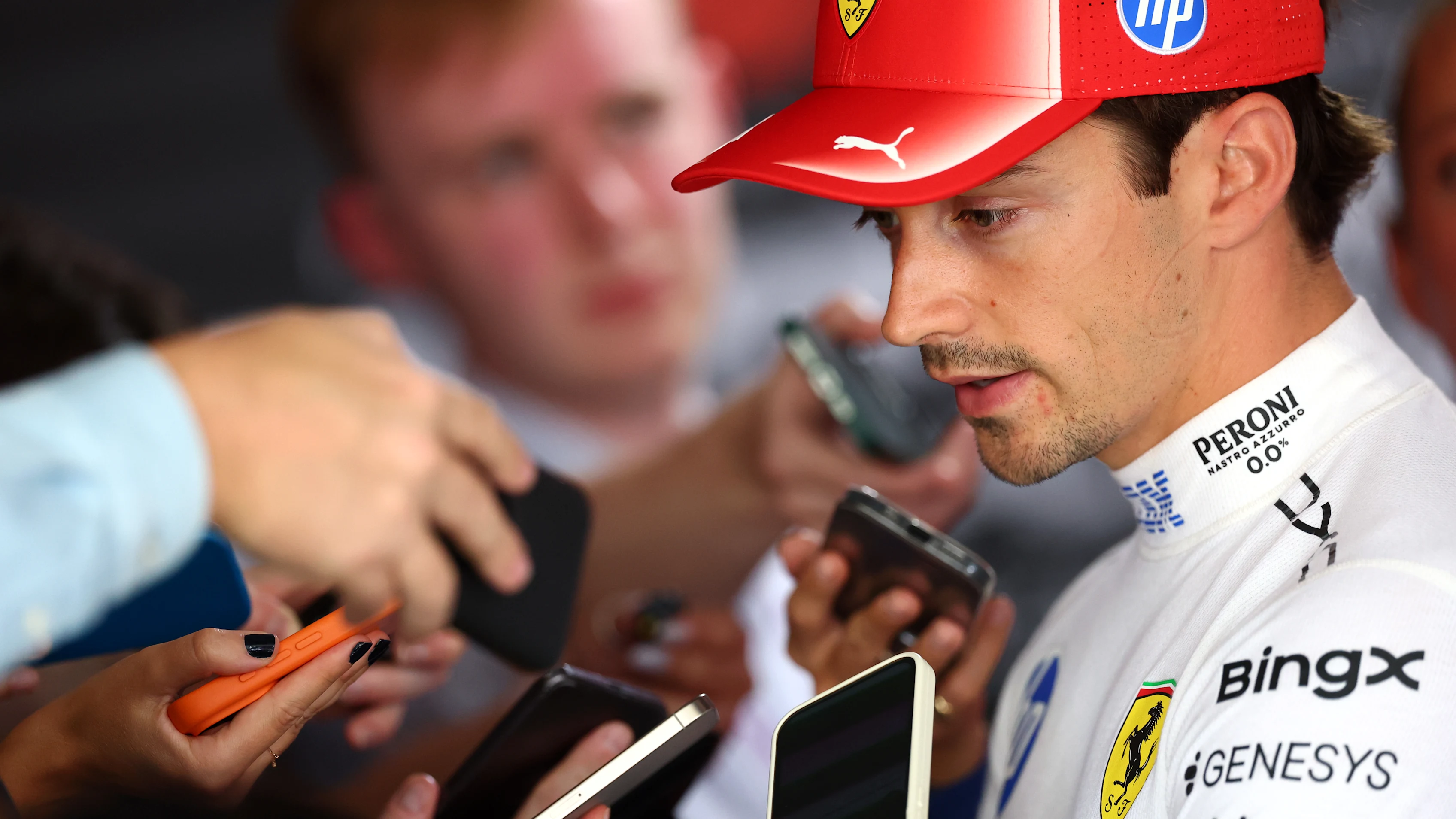 BARCELONA, SPAIN - JUNE 13: Charles Leclerc of Monaco and Scuderia Ferrari looks on in the garage