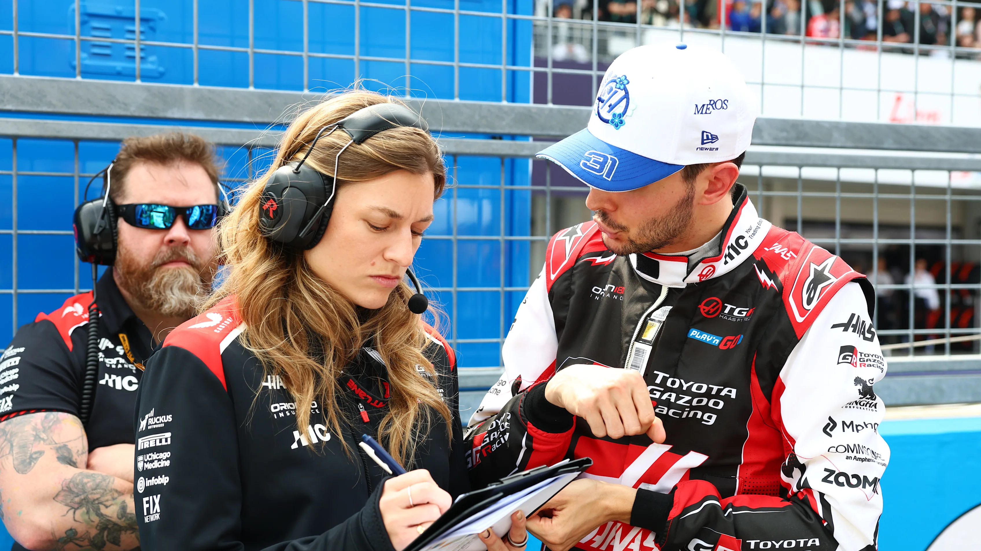 SUZUKA, JAPAN - MARCH 29: Laura Mueller, Race Engineer of Haas F1 and Esteban Ocon of France and