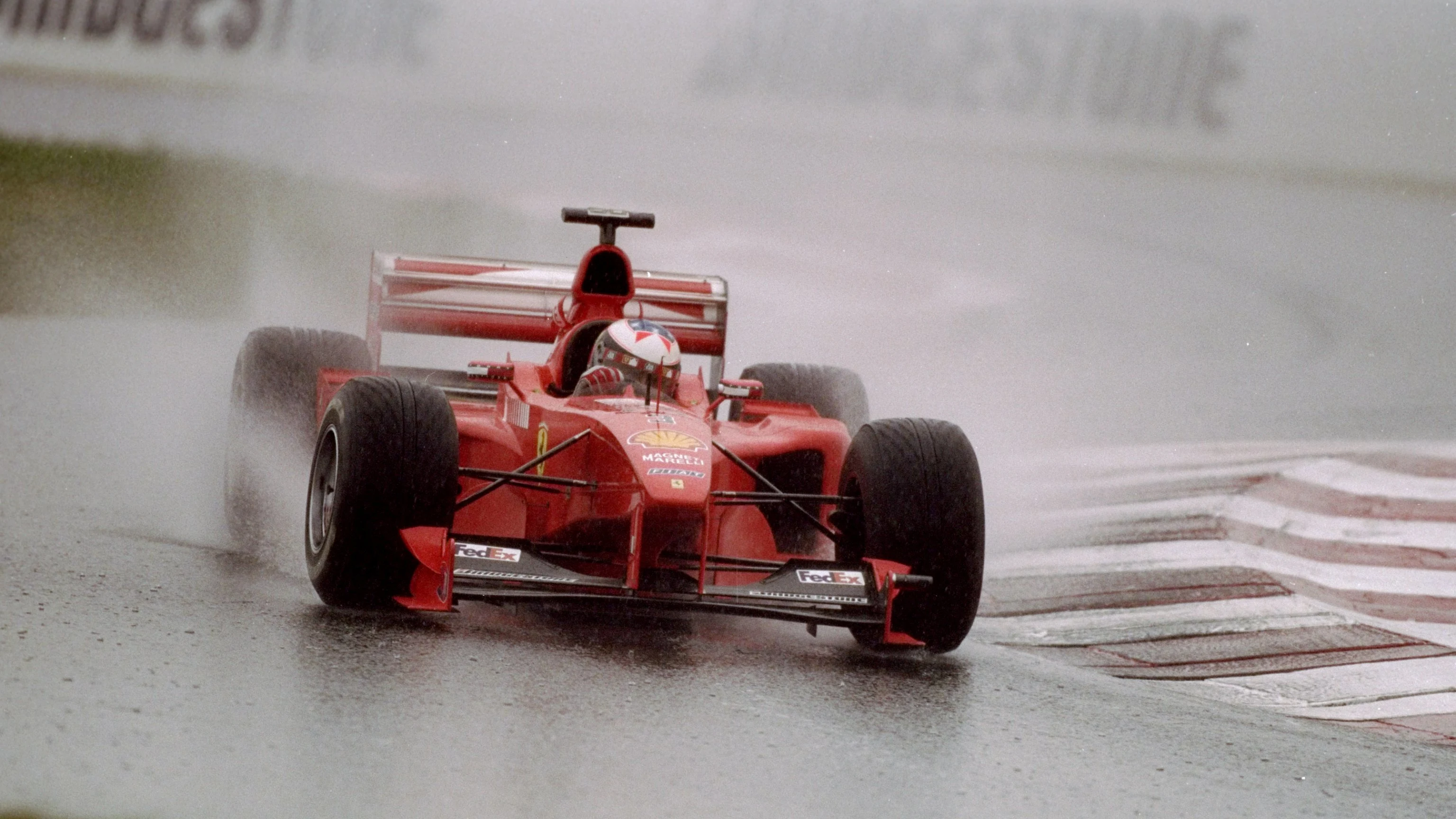 27 Jun 1999: Michael Schumacher carves through the rain in his Ferrari during the French Grand