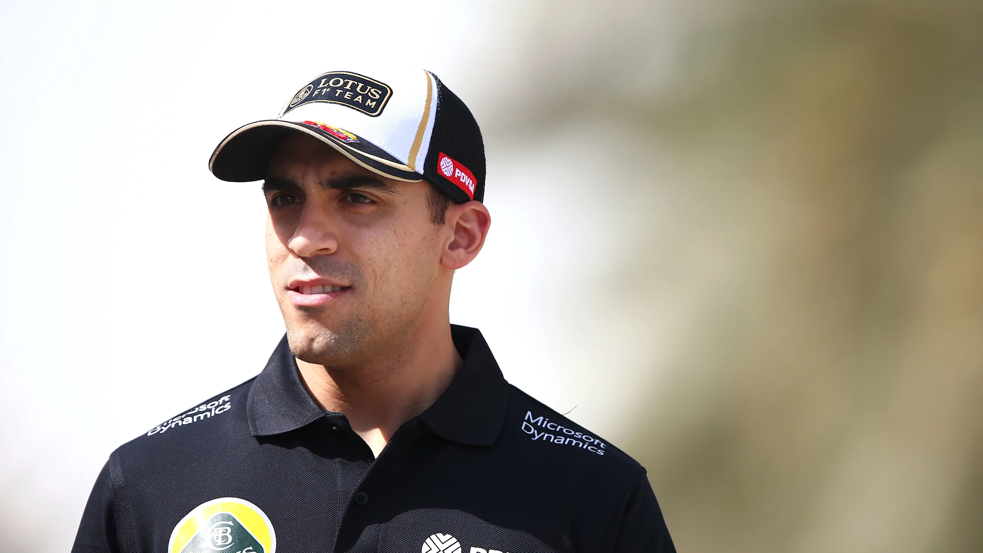 BAHRAIN, BAHRAIN - APRIL 16:  Pastor Maldonado of Venezuela and Lotus walks across the paddock