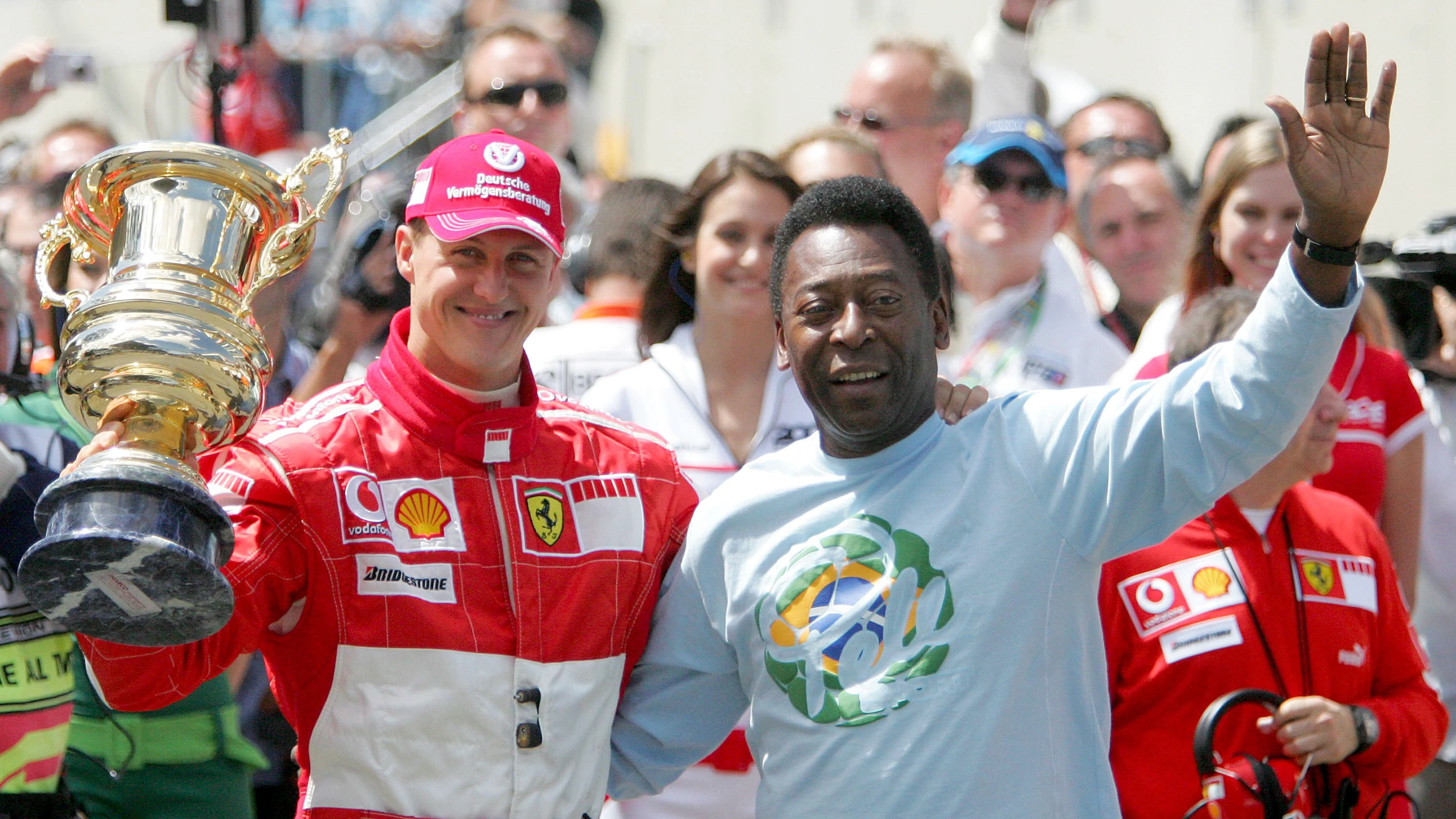 SAO PAULO, BRAZIL - OCTOBER 22:  Michael Schumacher of Germany and Ferrari (L) receives a trophy