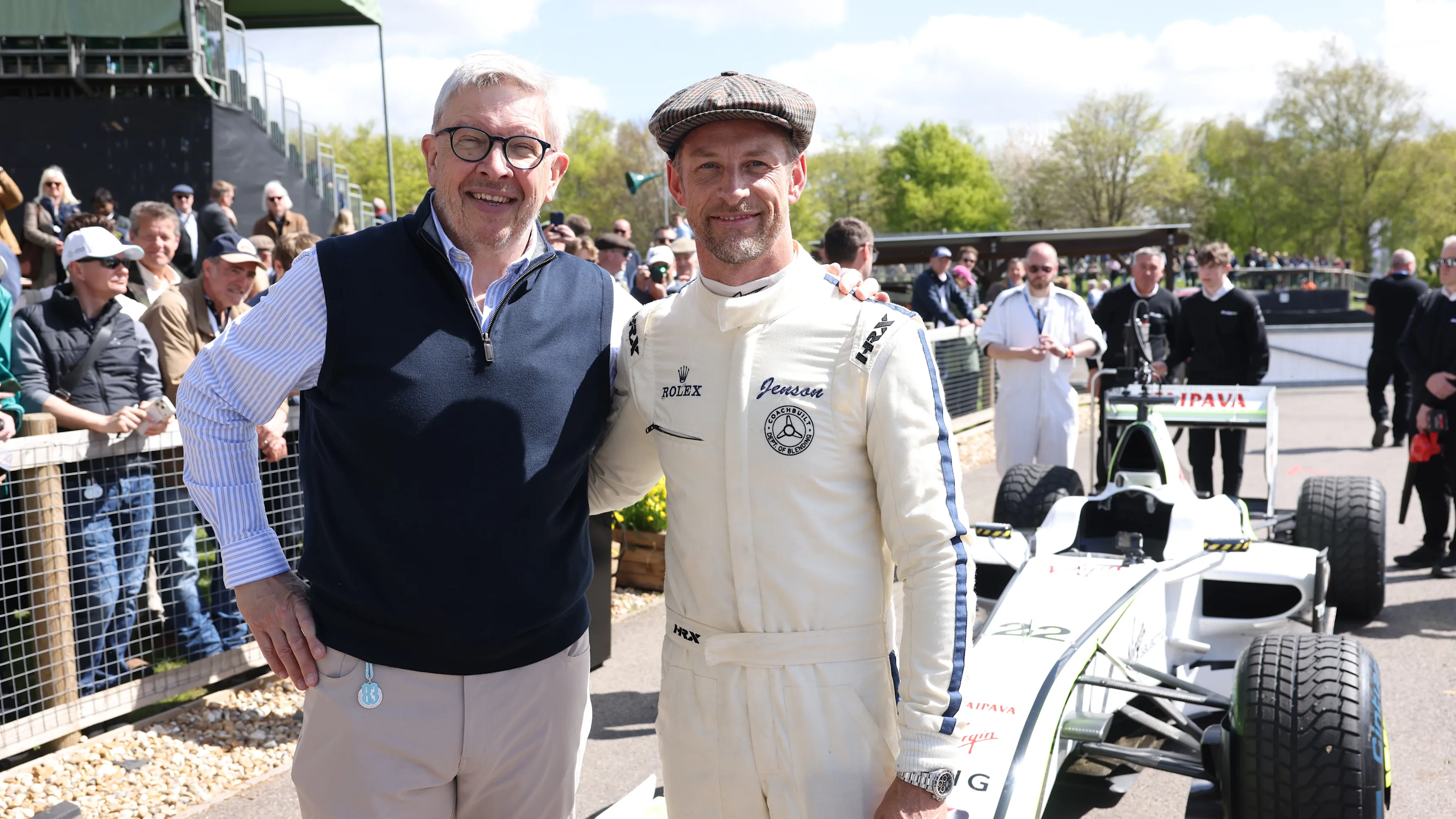 Jenson Button (right) poses with his 2009 Formula 1 World Championship‑winning Brawn BGP 001