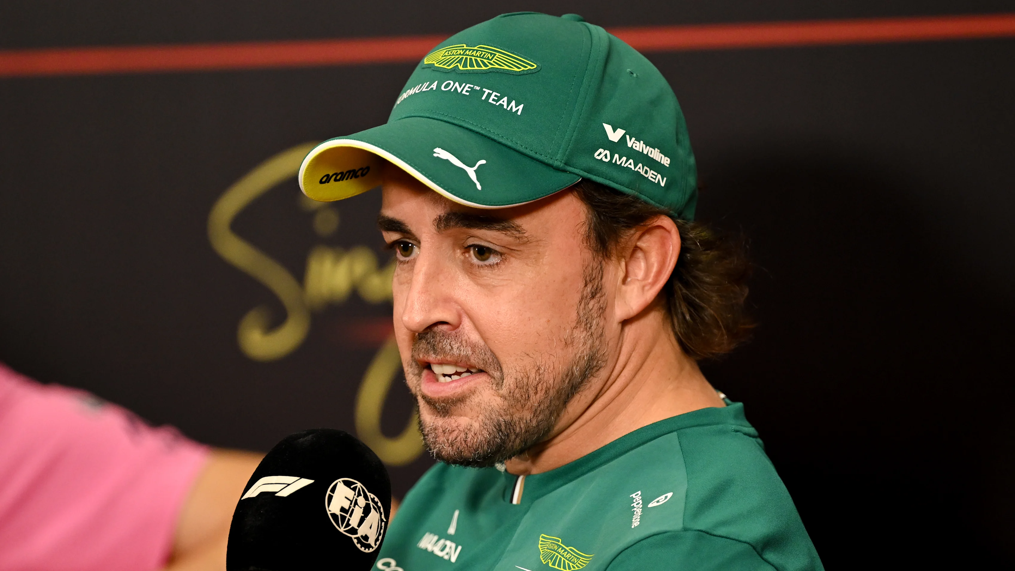 SINGAPORE, SINGAPORE - OCTOBER 08: Fernando Alonso of Spain and Aston Martin F1 Team speaks in the