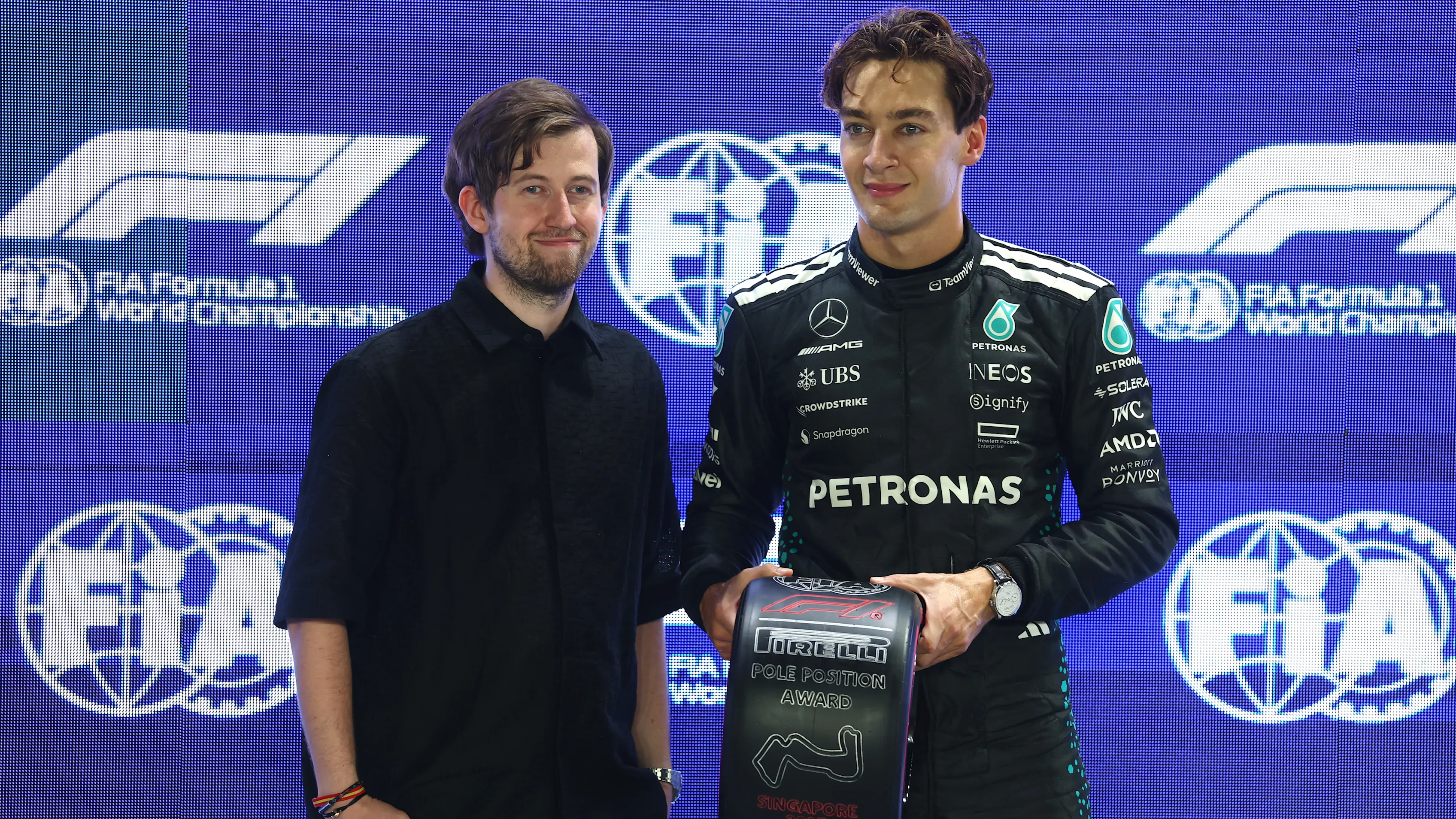 SINGAPORE, SINGAPORE - OCTOBER 04: Pole position qualifier George Russell of Great Britain and