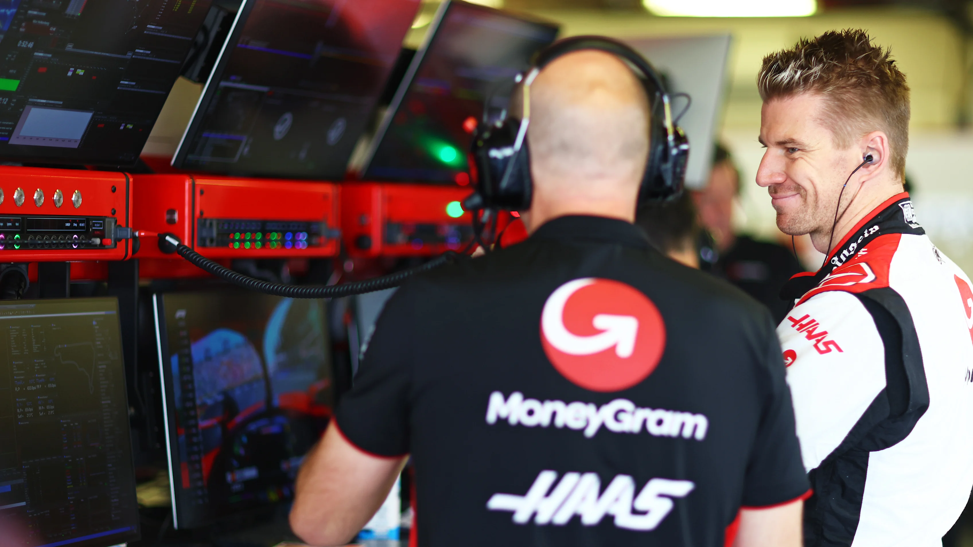 MEXICO CITY, MEXICO - OCTOBER 28: Nico Hulkenberg of Germany and Haas F1 talks with a Haas F1 team